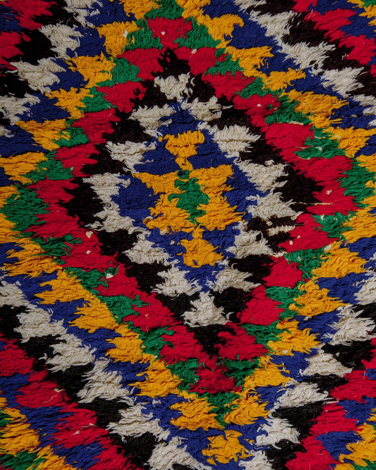 Close up of boucherouite rug surface with colourful cotton.