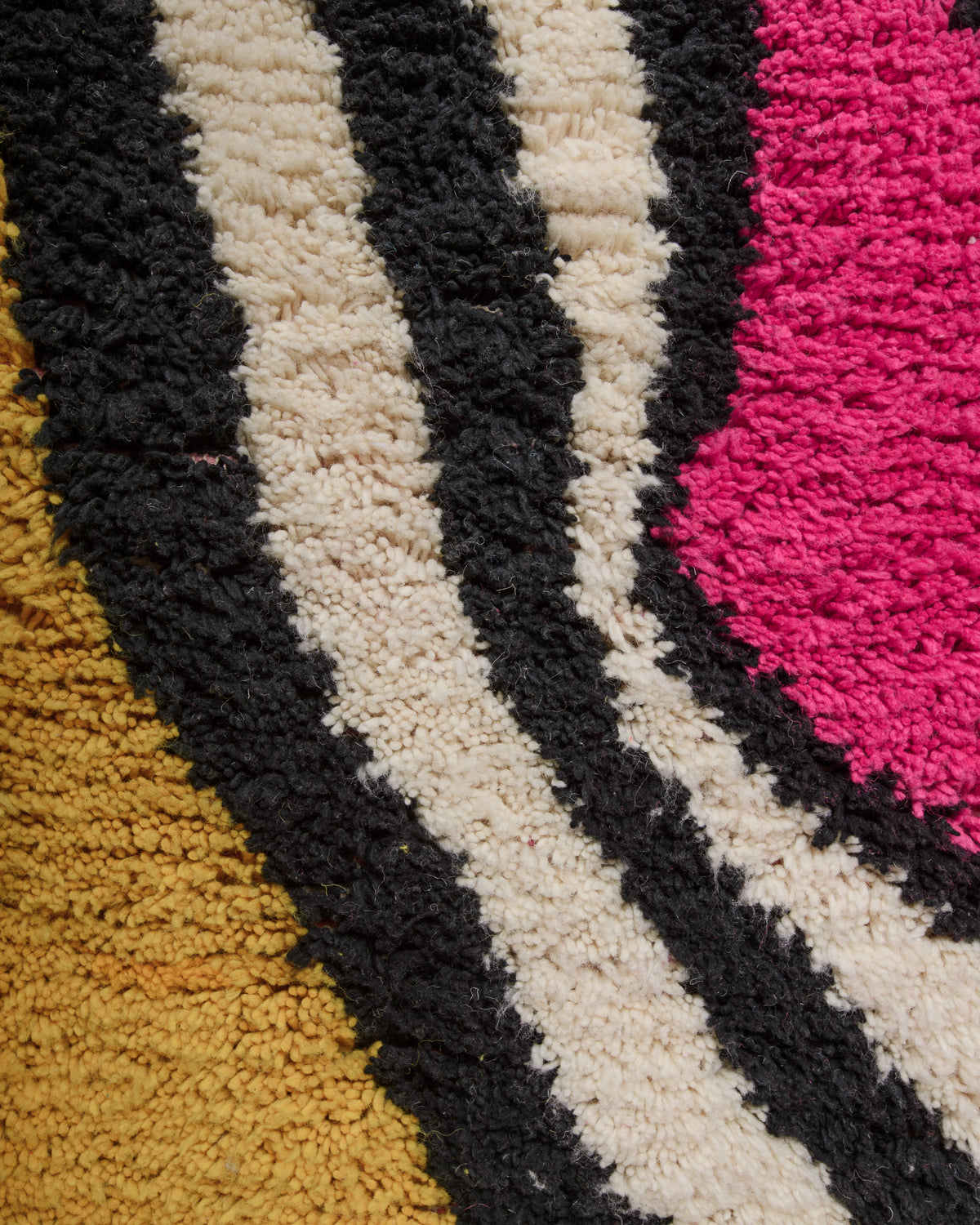Close up of vintage boujaad rug showing the different shades of wool and surface texture.