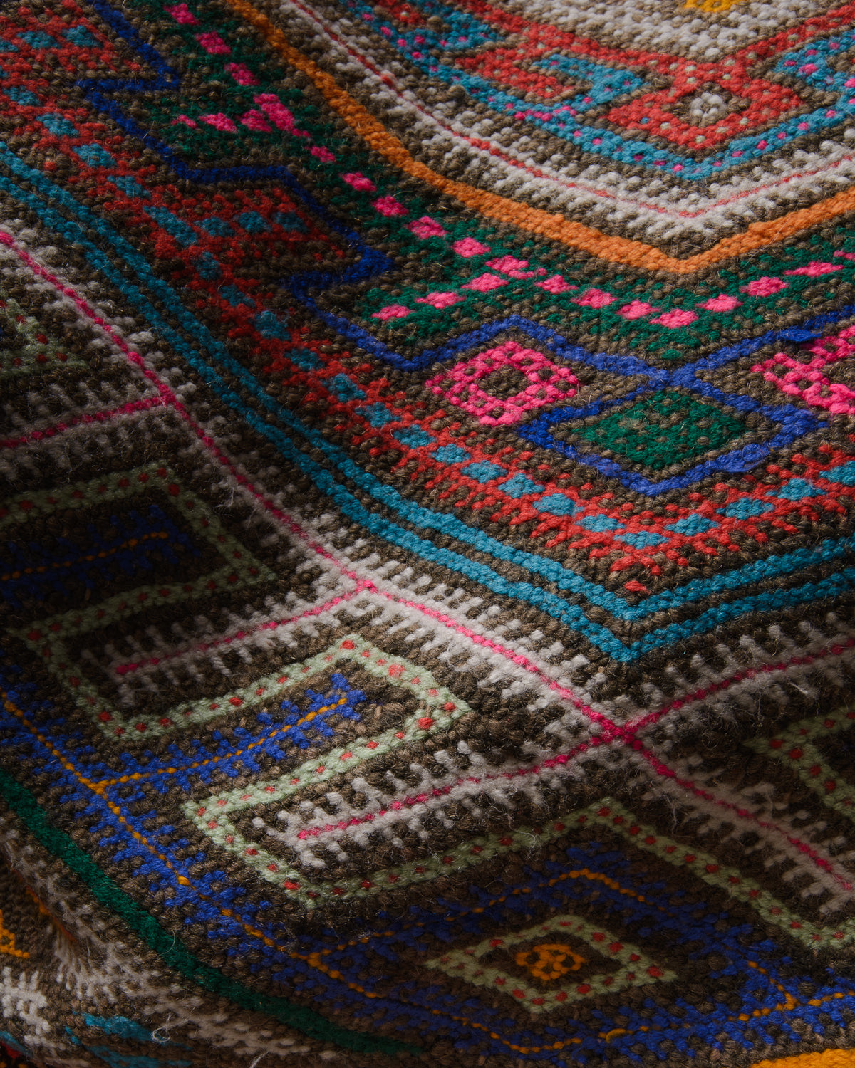 Surface details of colourful vintage kelim rug.