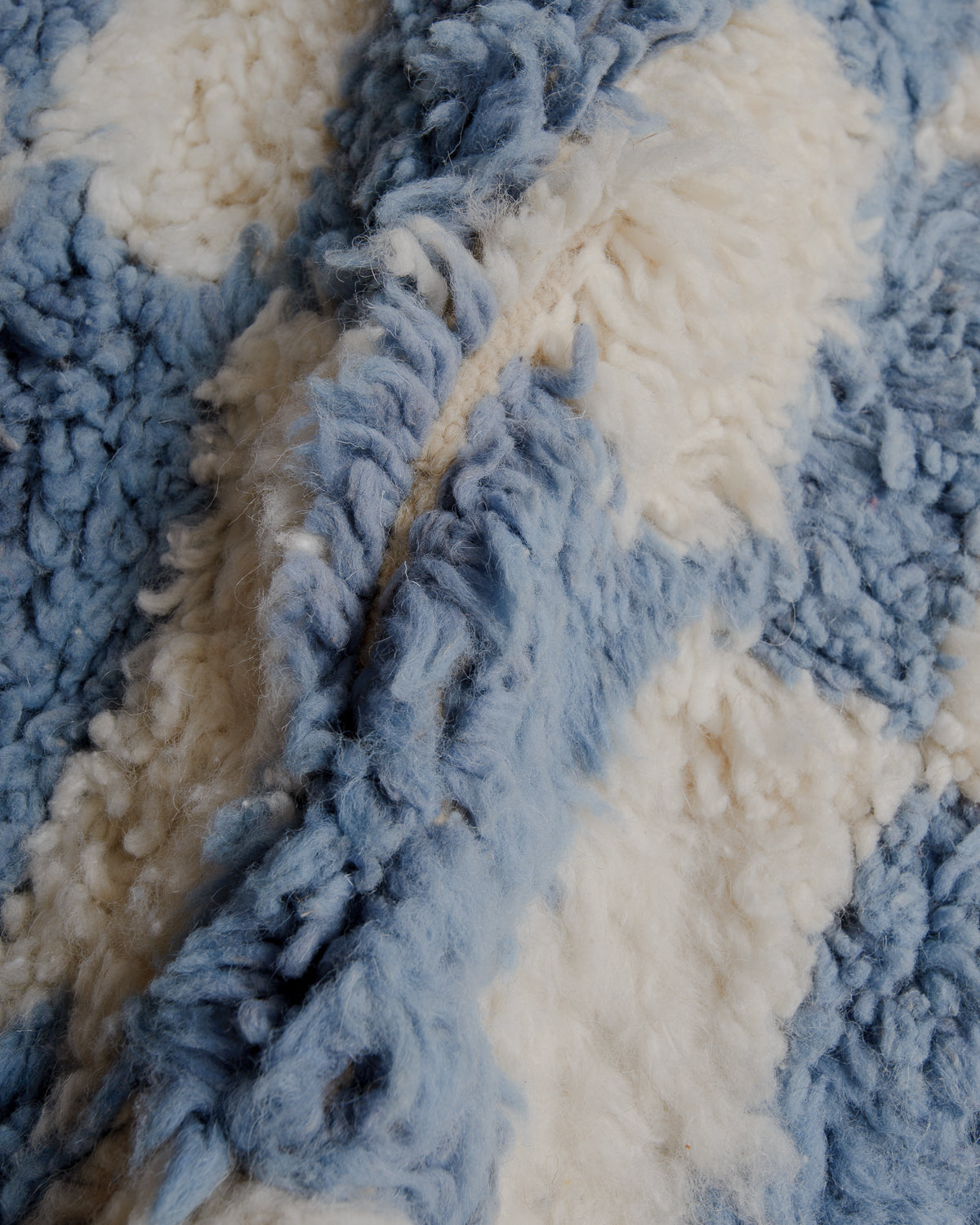 Fluffy wool rug in cream and blue.