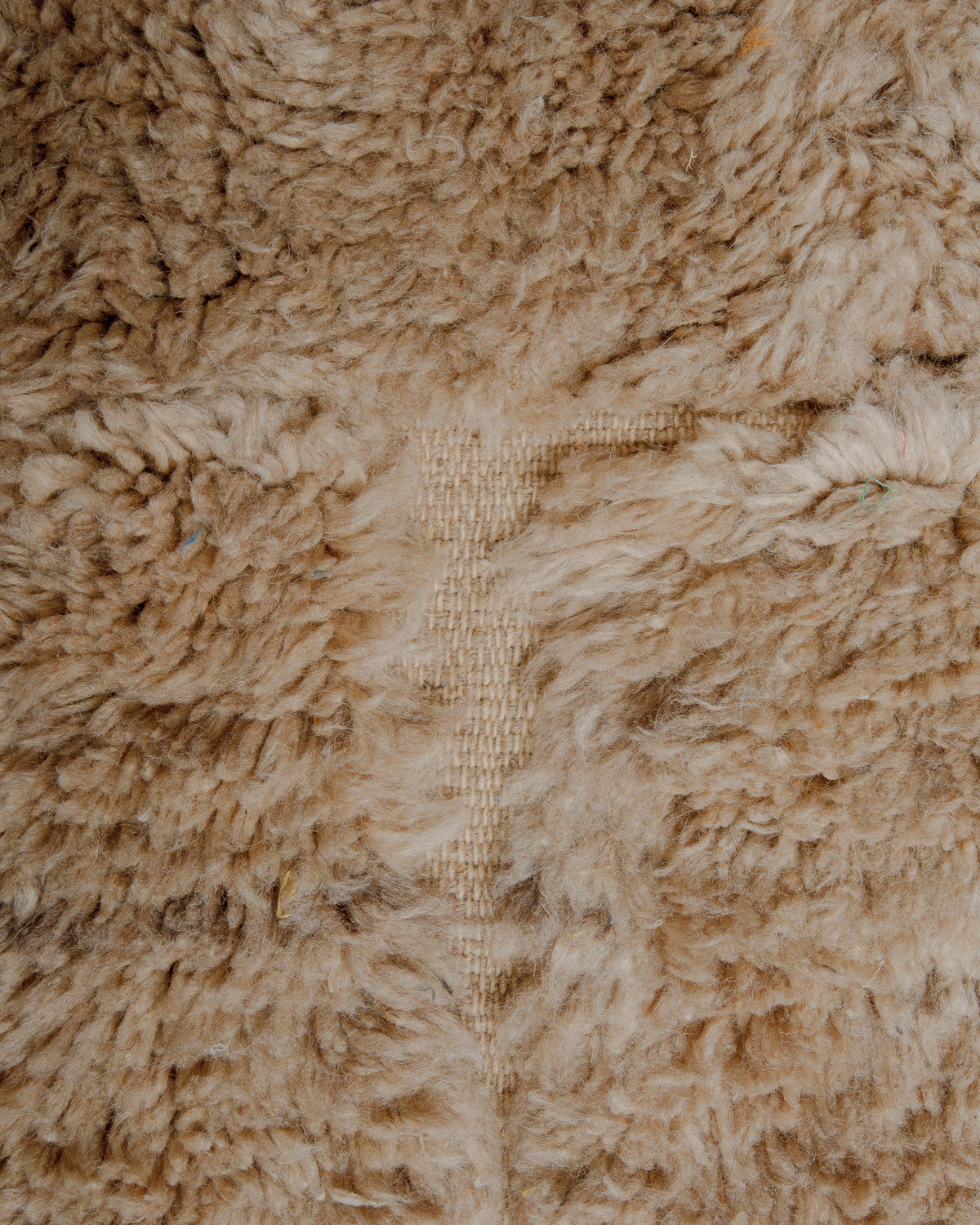 Fluffy brown wool with flat woven areas.