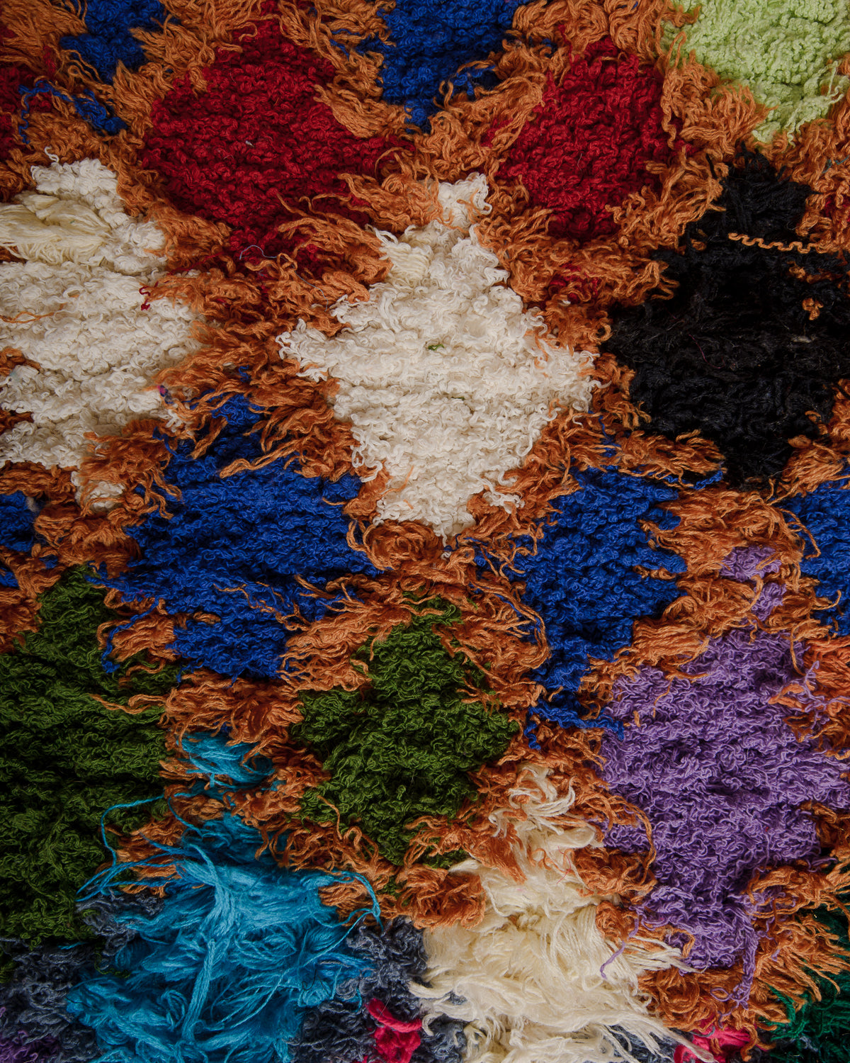 Surface of rug with ochre, red, blue, cream and green cotton