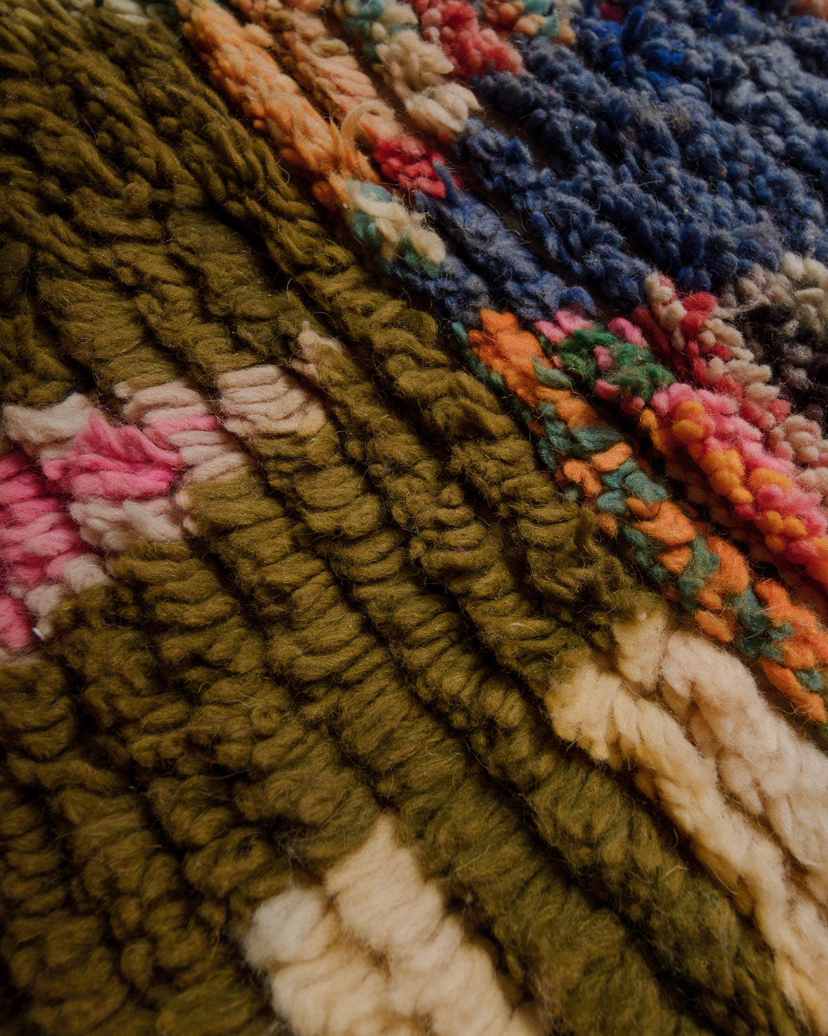 Close up of Boujaad rug with pink, rose, khaki green, blue, orange and cream wool.