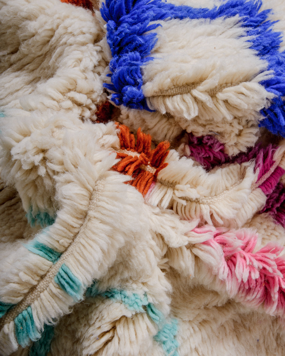 Close-up of a fluffy Azilal rug, showcasing the intricate spacing of the rows and the dense wool pile texture.