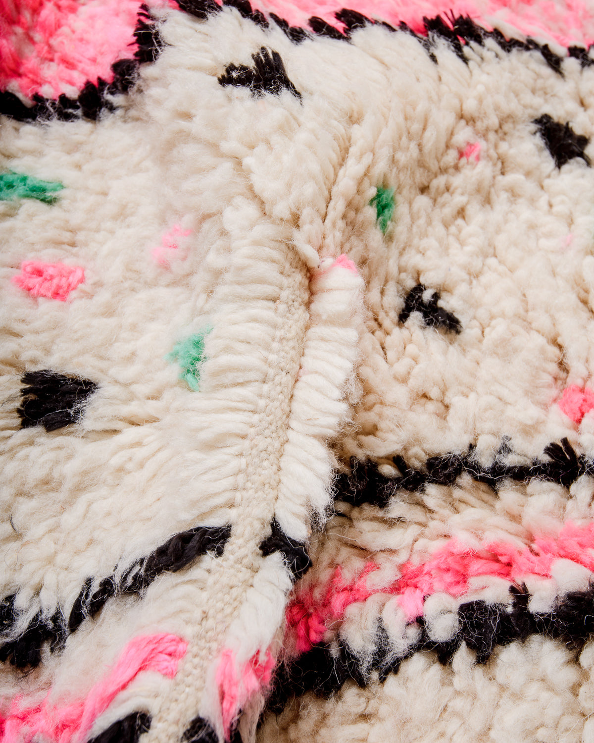 Close-up of a fluffy Azilal rug, showcasing the intricate spacing of the rows and the dense wool pile texture.