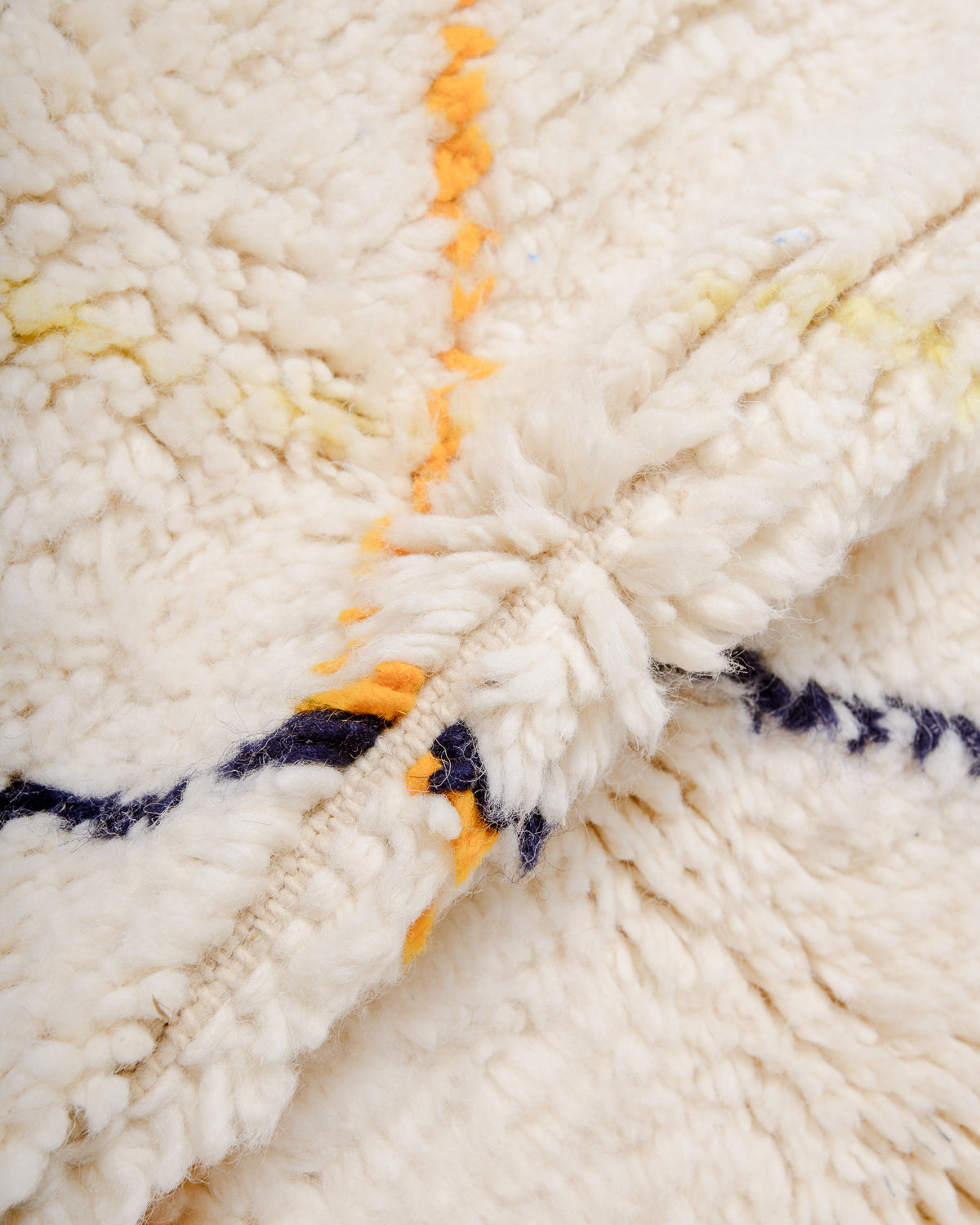 Detail of cream wool pile of Beniourain rug.