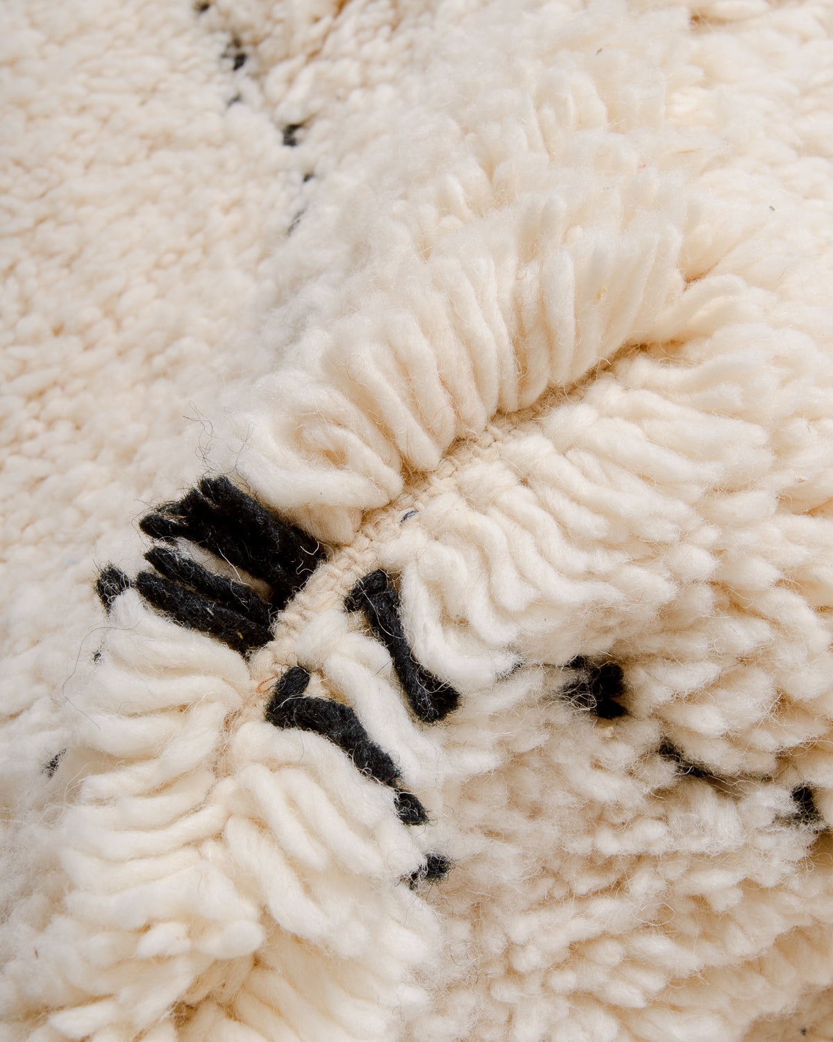 Detail of wool of cream and black Berber rug.