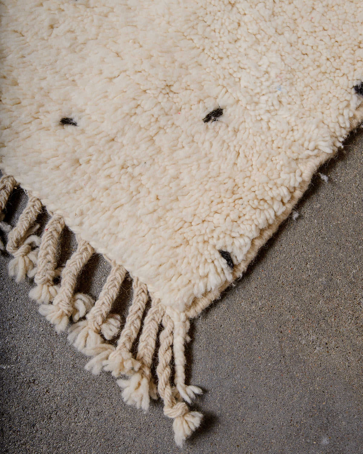 Corner of rug showing natural wool tassels.
