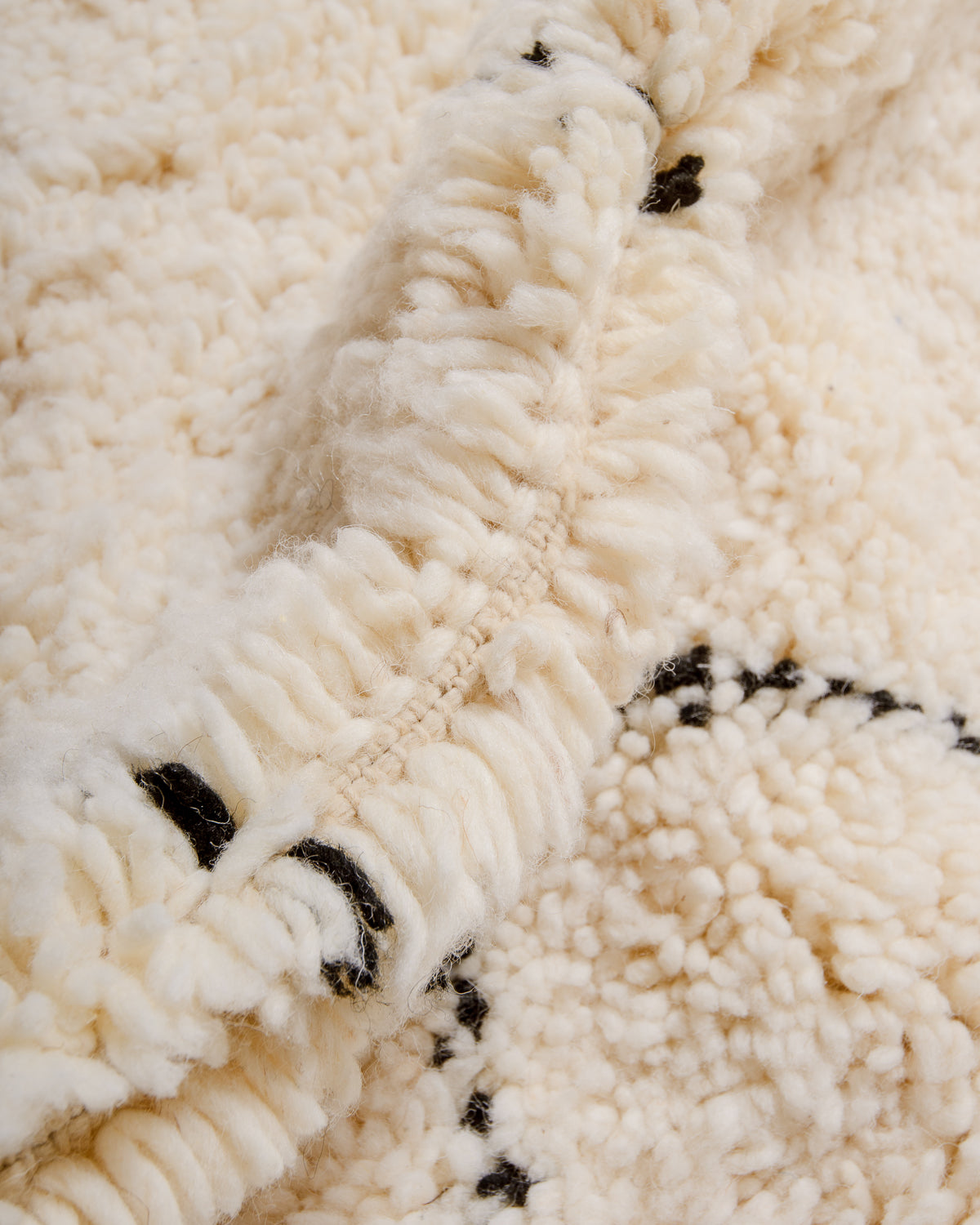 Close up of thick wool texture of berber rug.
