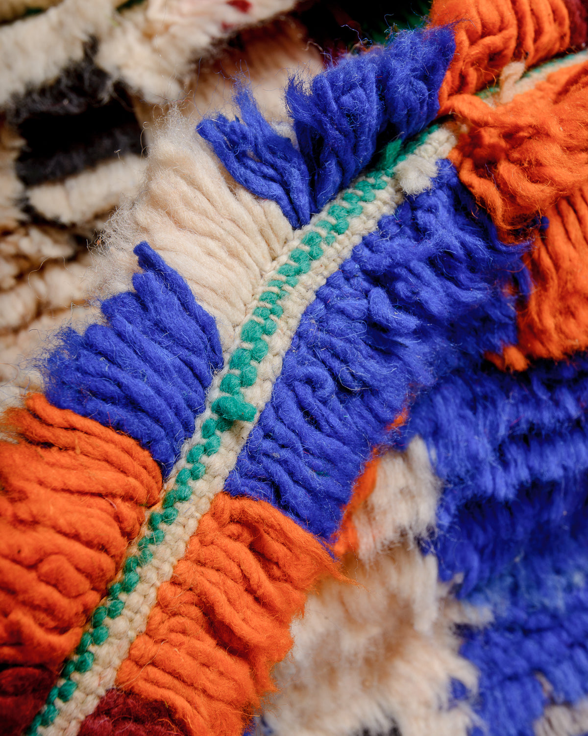 Detail of colourful berber rug showing the density of the knots and the length of the wool.