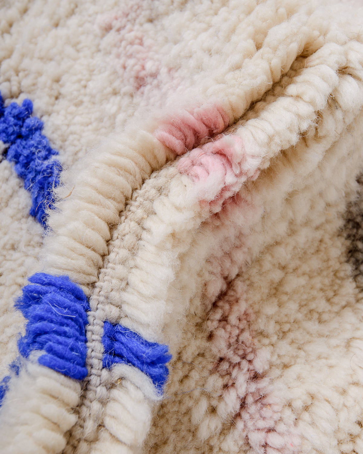 Detail of Berberlin finest Beniourain rug showing thick wool pile and dense knots.