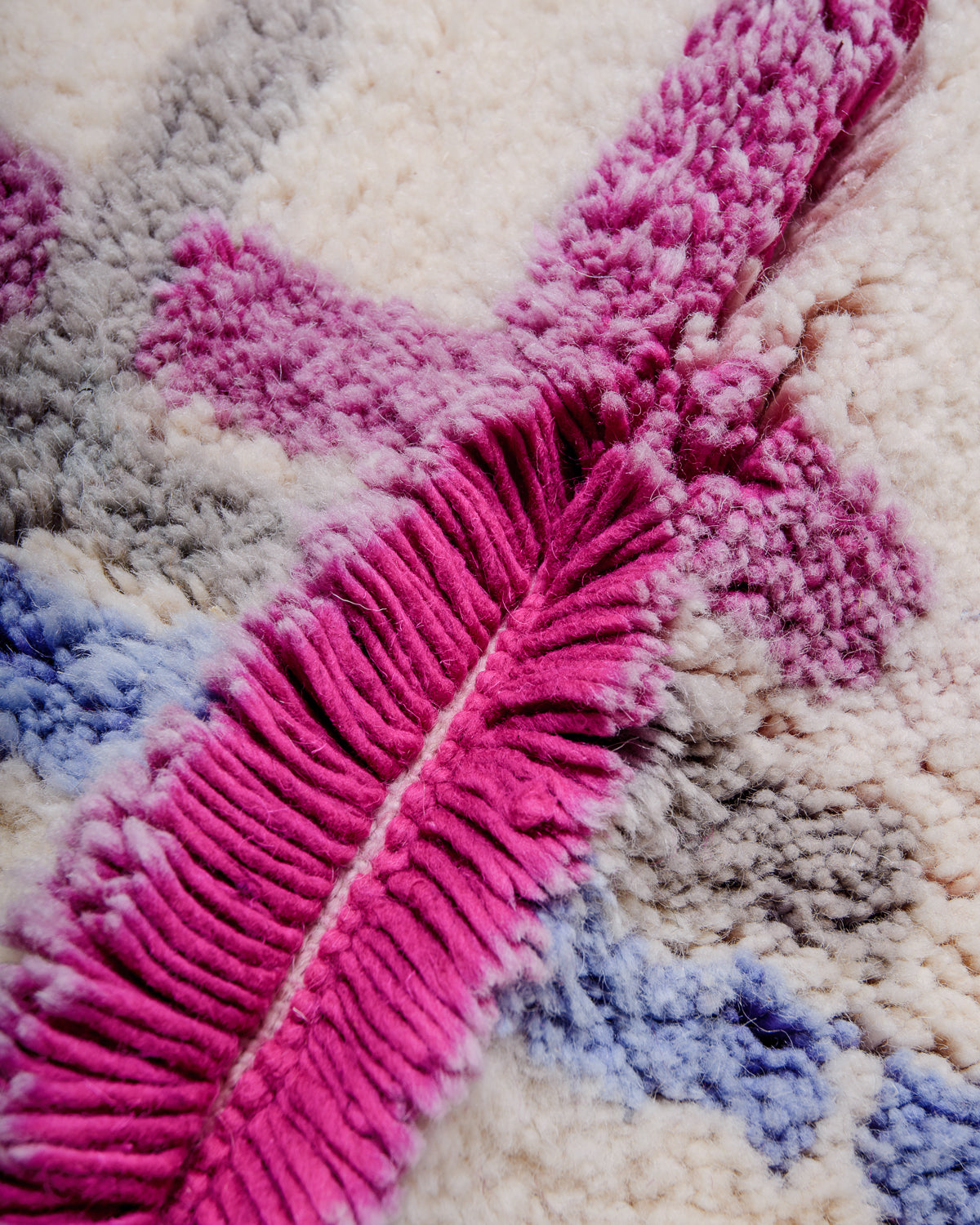Detail of wool of Berberlin finest Beniourain rug showing thick wool pile and dense knots, and the slight colour fading at the tips of the wool strands.