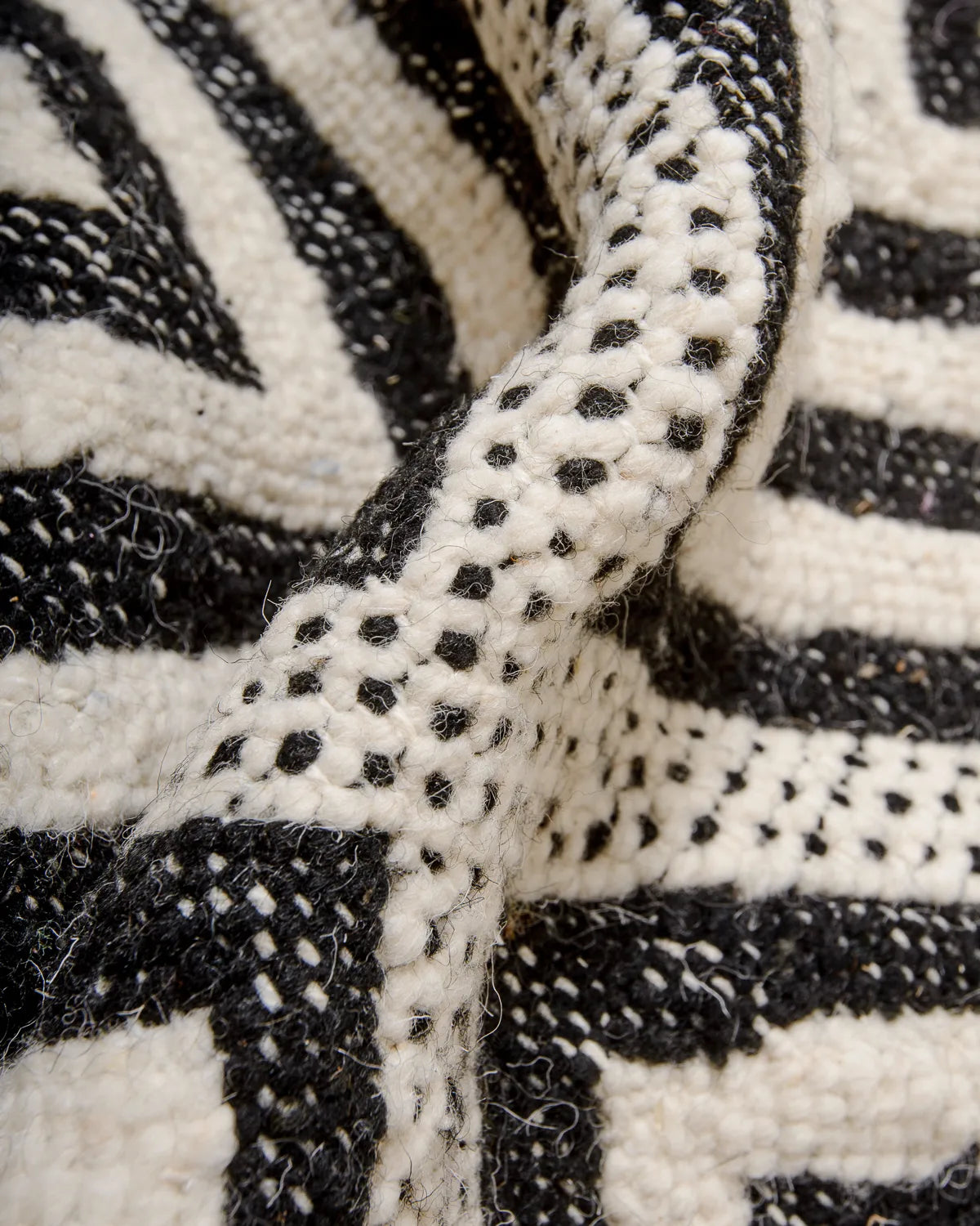 Detail of black and white Kelim rug made of wool.