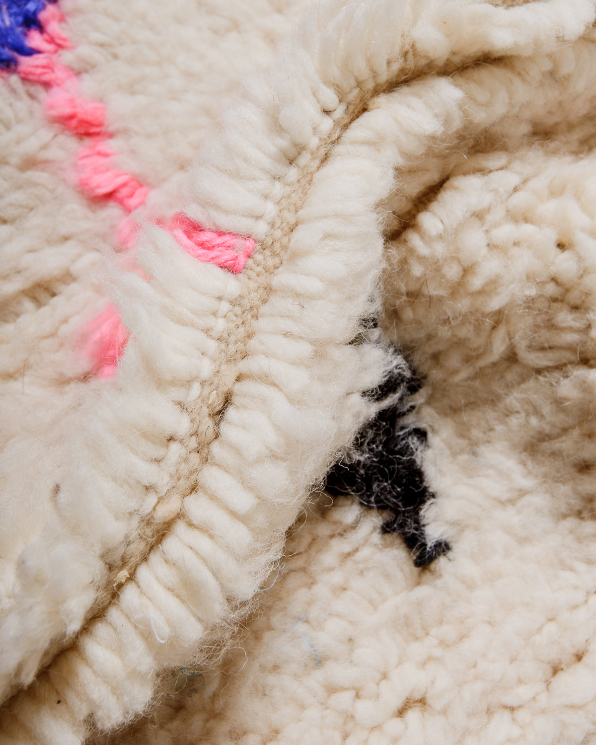 Detail of Azilal rug showing the spacing of the knotted wool rows and fluffy wool texture.