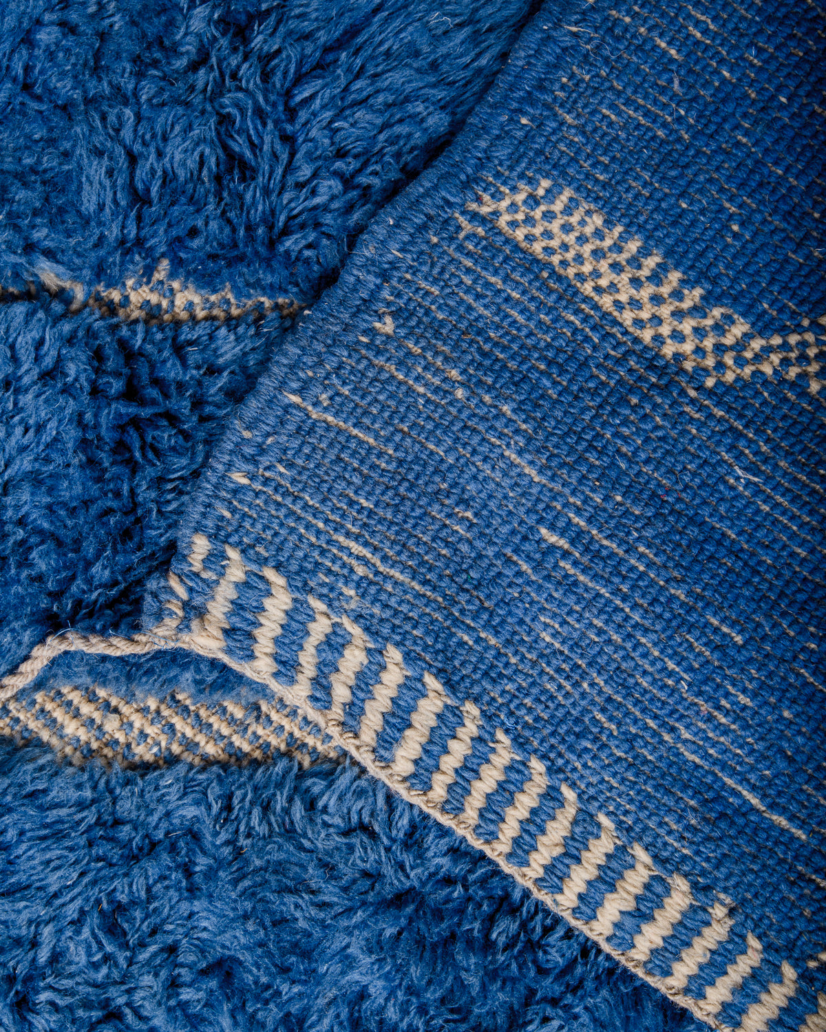 Corner of rug folded over showing the density of the rows of knots that make a Beni M'rirt.