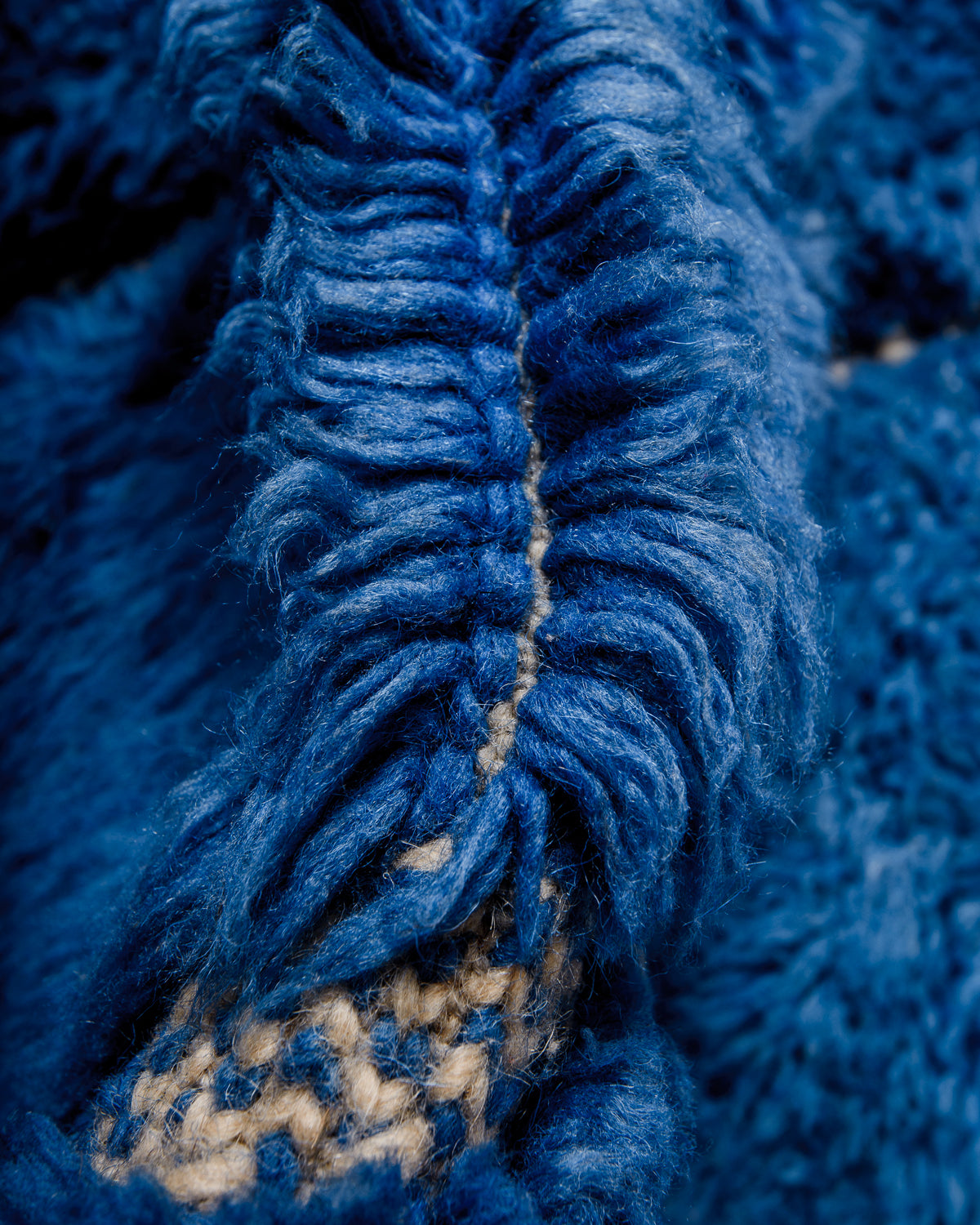 Detail of wool of Berberlin M'rirt rug showing thick wool pile and dense knots.