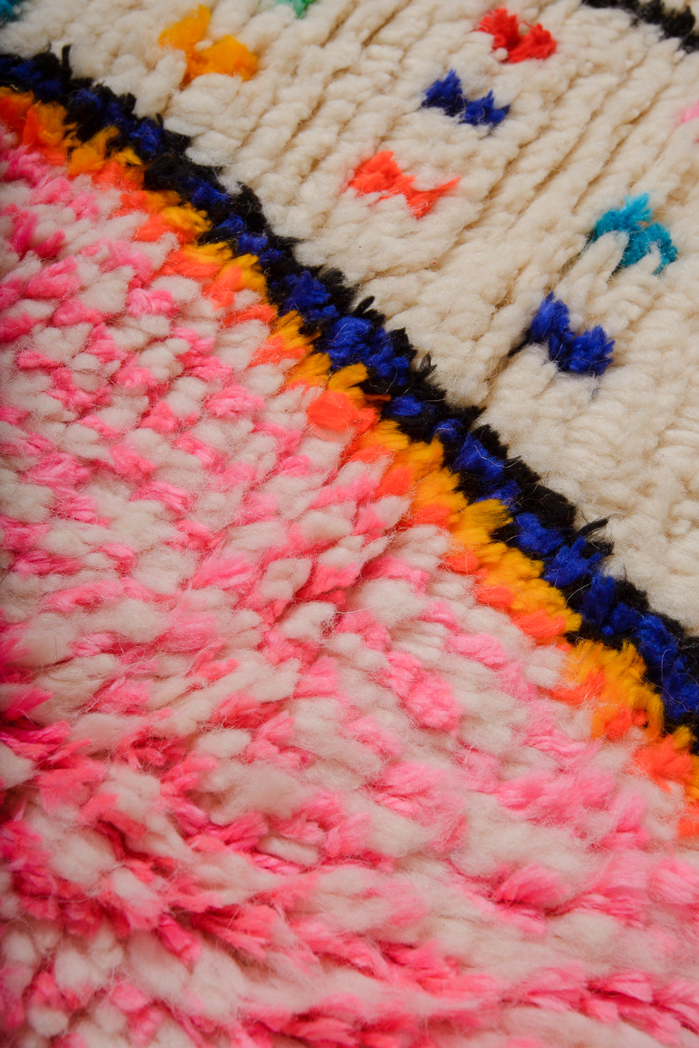Detail of Azilal rug showing the fluffy wool texture and cotton colours.