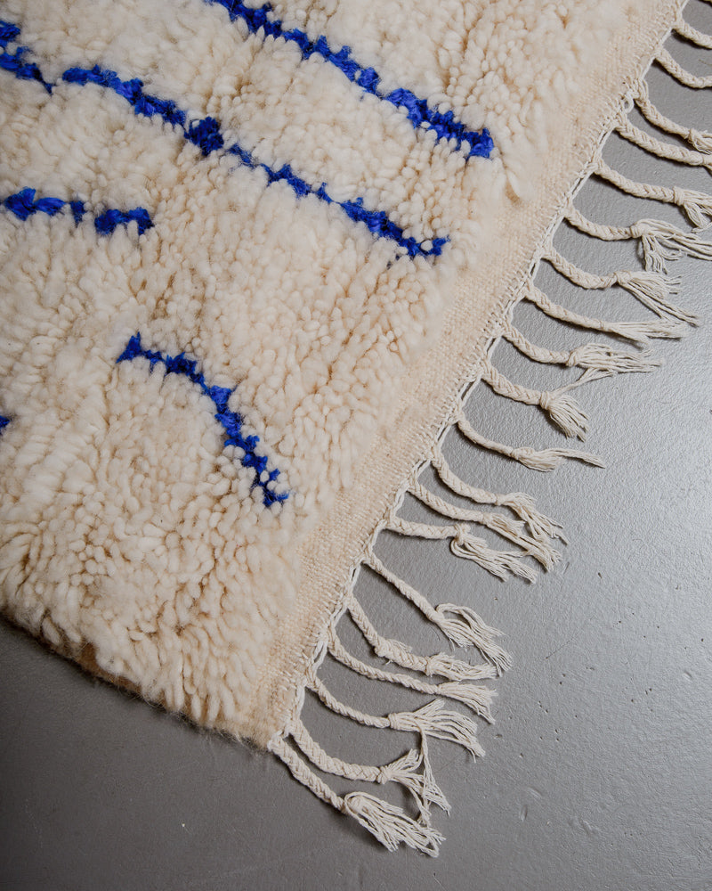 Corner of azilal rug with white cotton tassels. 