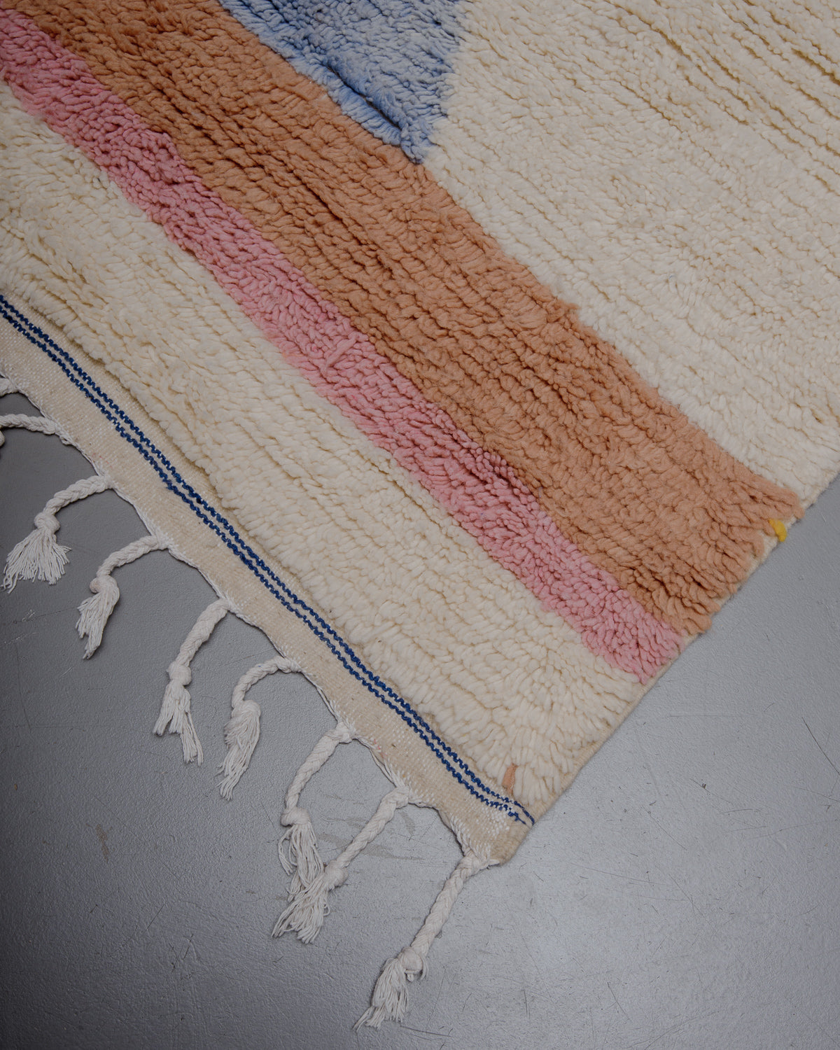 Edge of azilal rug with cotton tassels. 