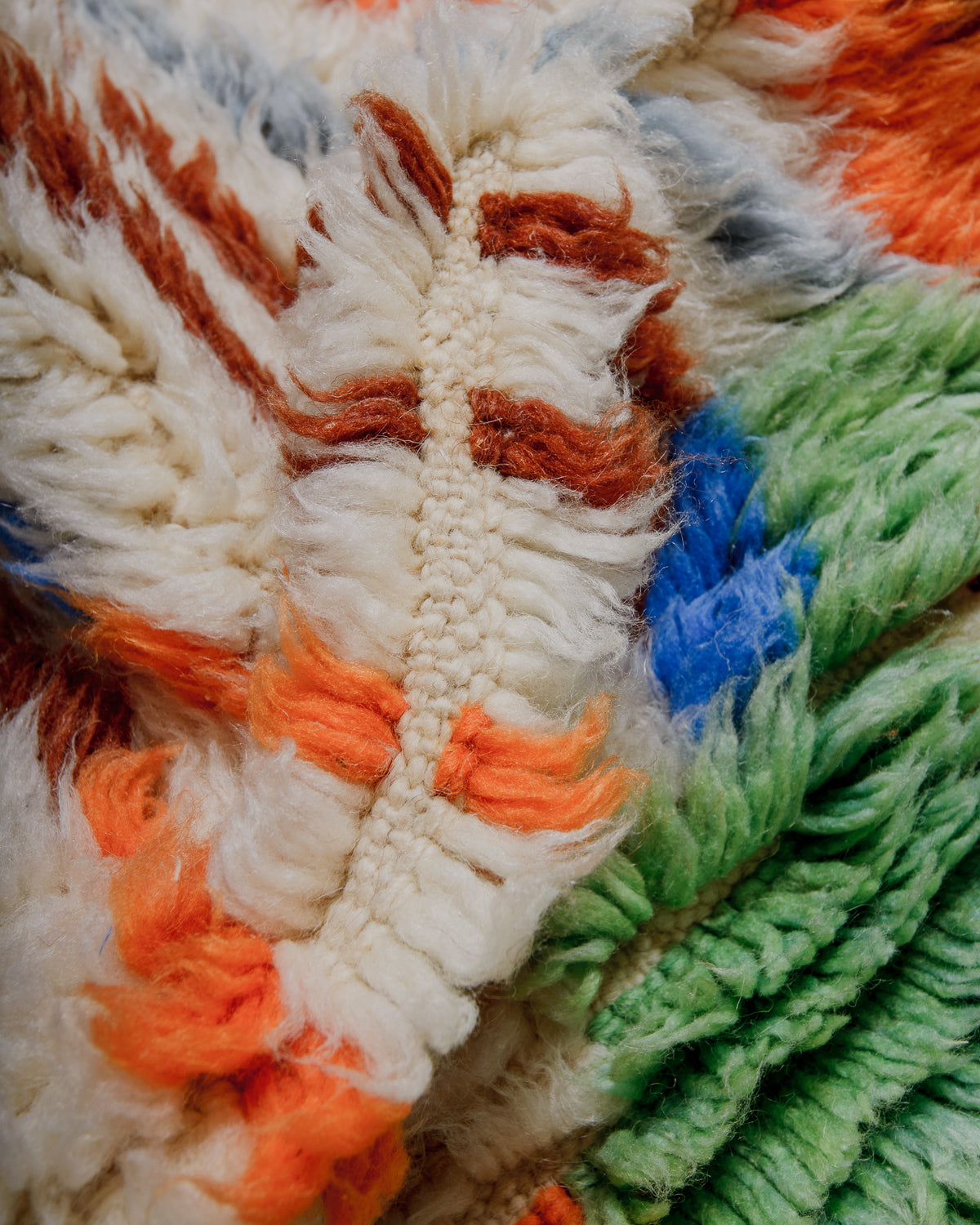 Close-up of a textured wool rug with multicolor threads
