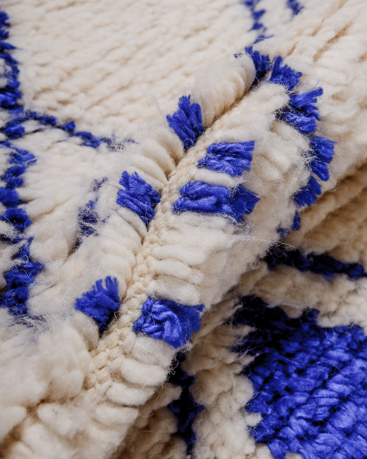 Detail of Azilal rug showing the spacing of the knotted wool rows and fluffy wool texture.
