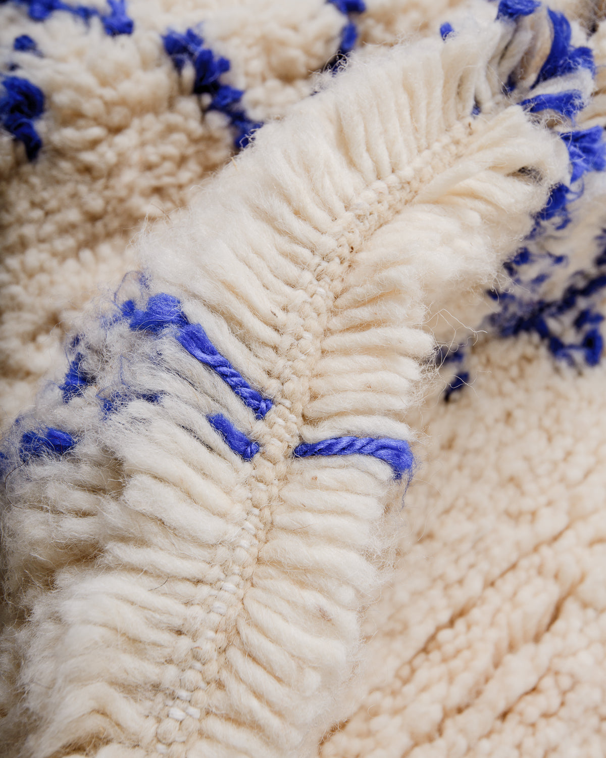 Detail of Azilal rug showing the spacing of the knotted wool rows and fluffy wool texture.