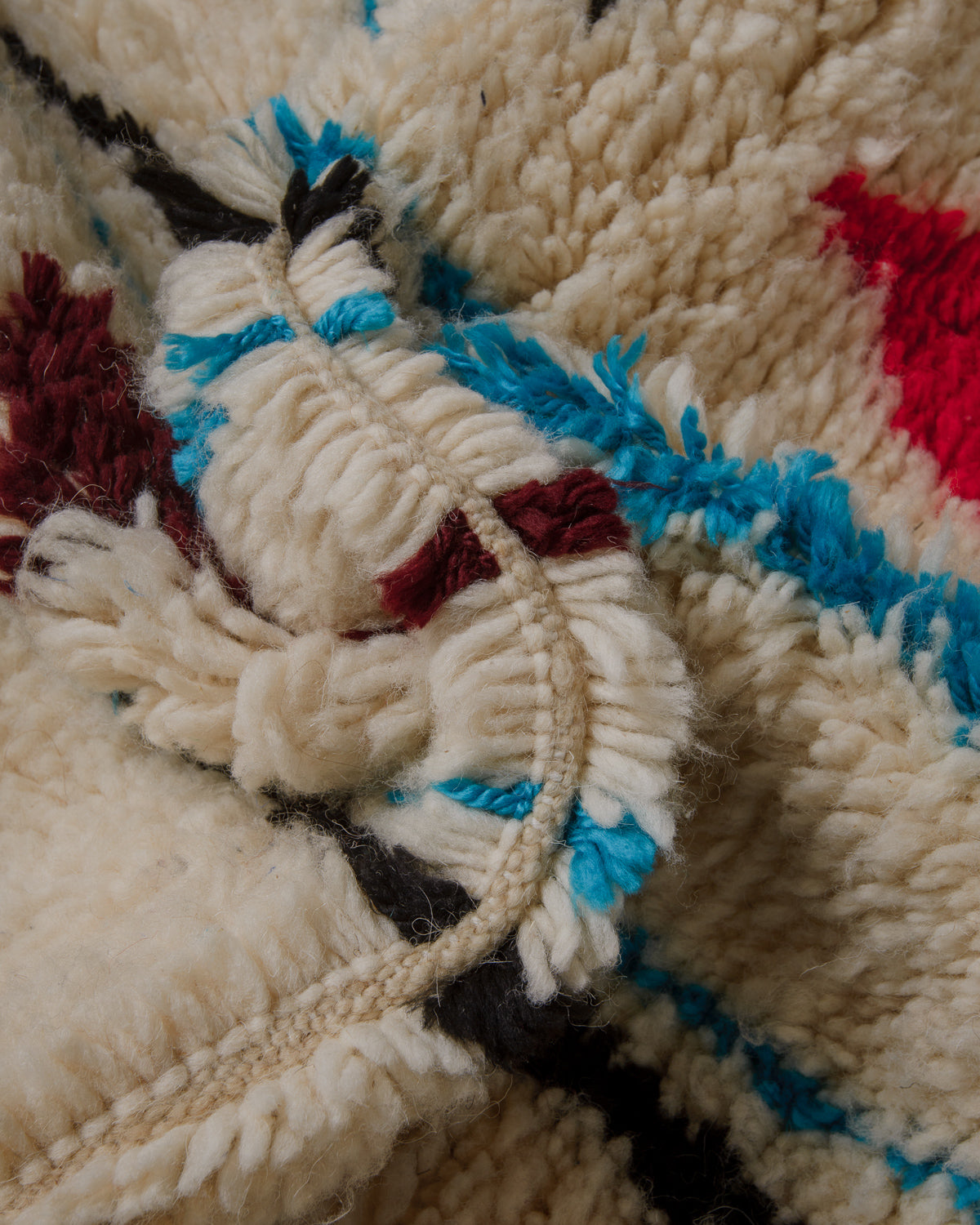 Close up of Azilal rug showing fluffy pile and extra row between the knots.