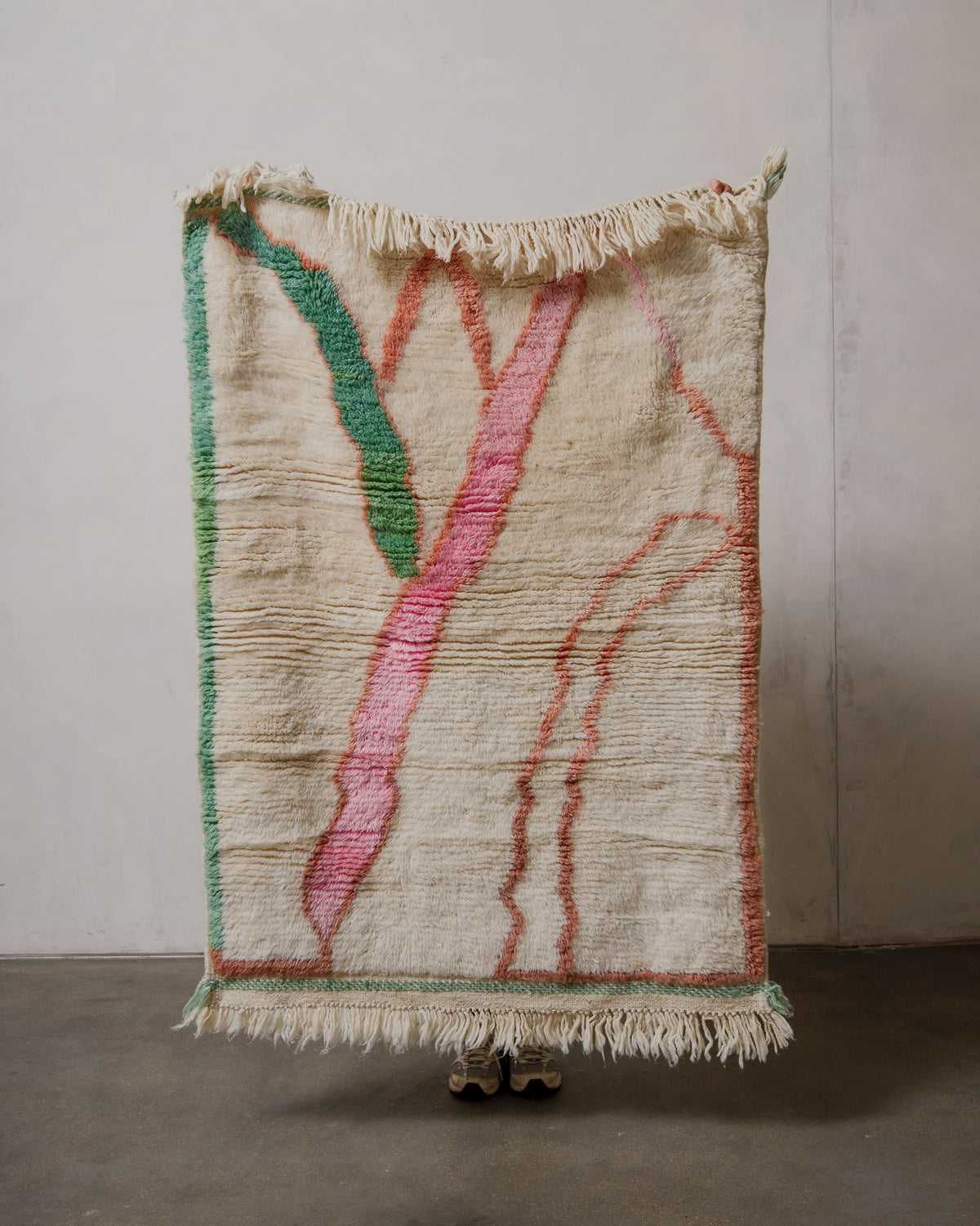 Textured rug with colorful abstract design on a plain background