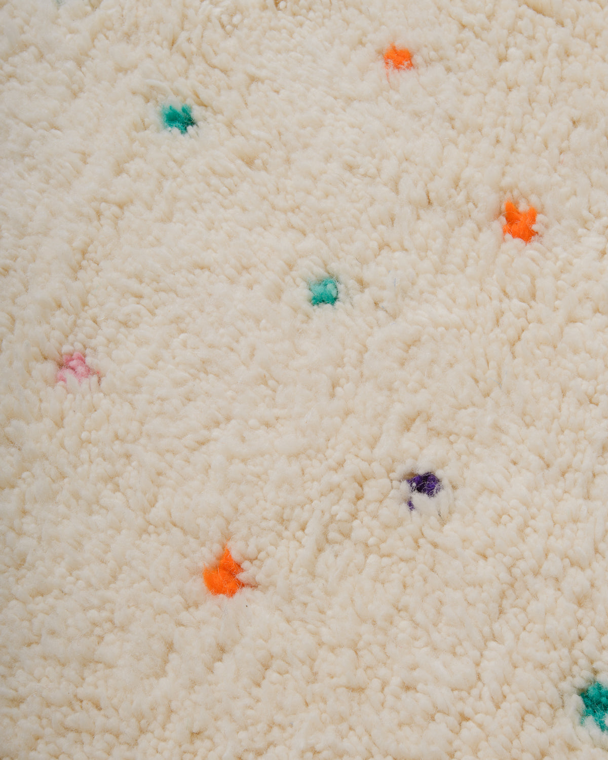 Detail view of Beniourain Rug showing its colourful dots.