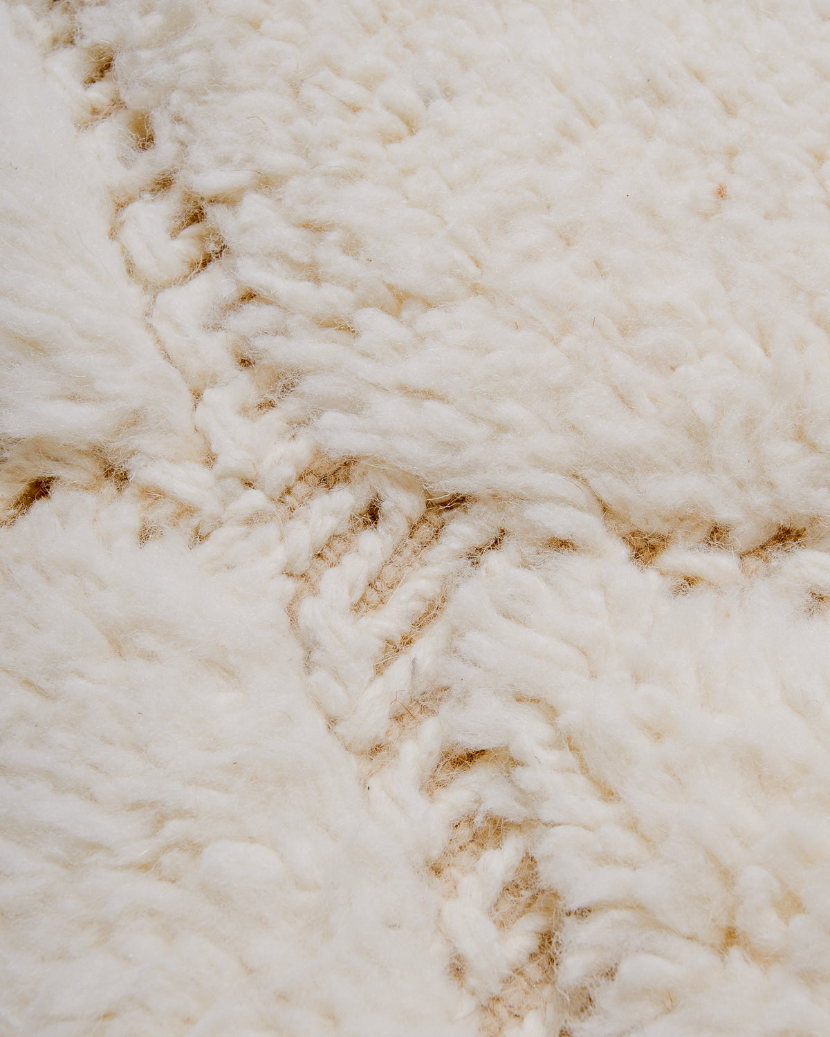 Detail view of woven and embroidered diamond design. 