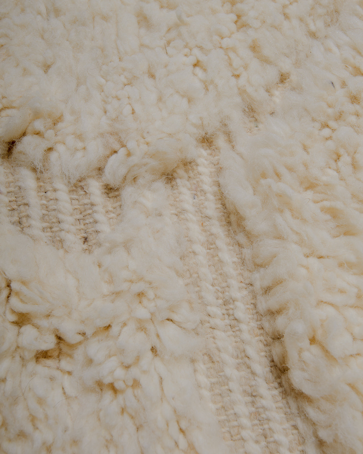 Close up of cream wool rug.