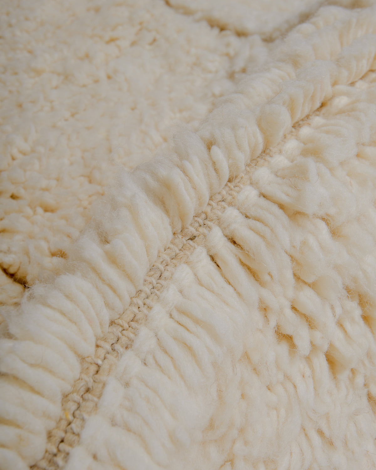 Close up of cream wool rug.