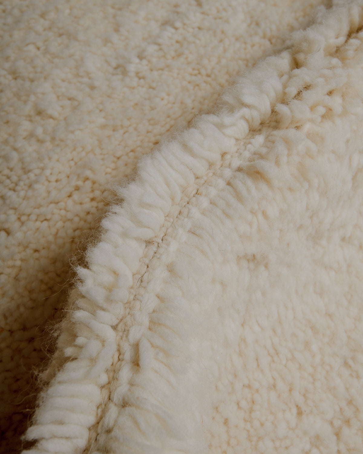 Close up of cream wool rug.