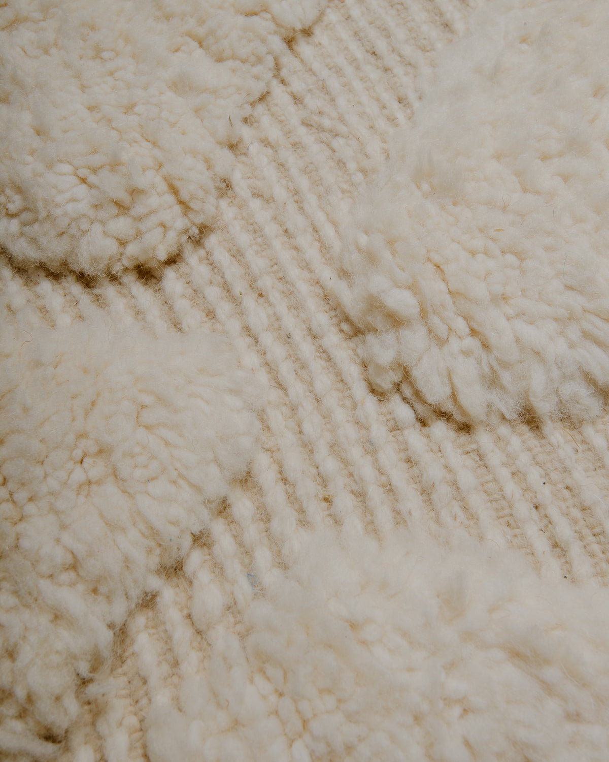 Close up of cream wool rug.