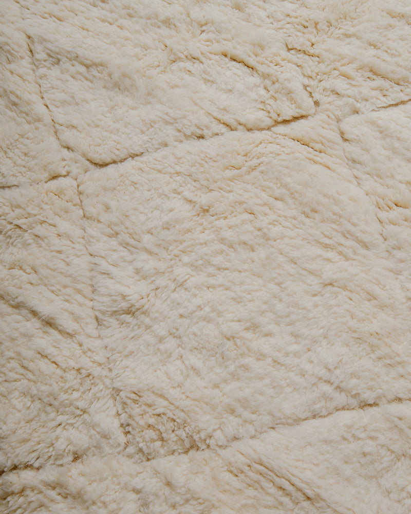 Surface of cream wool rug.