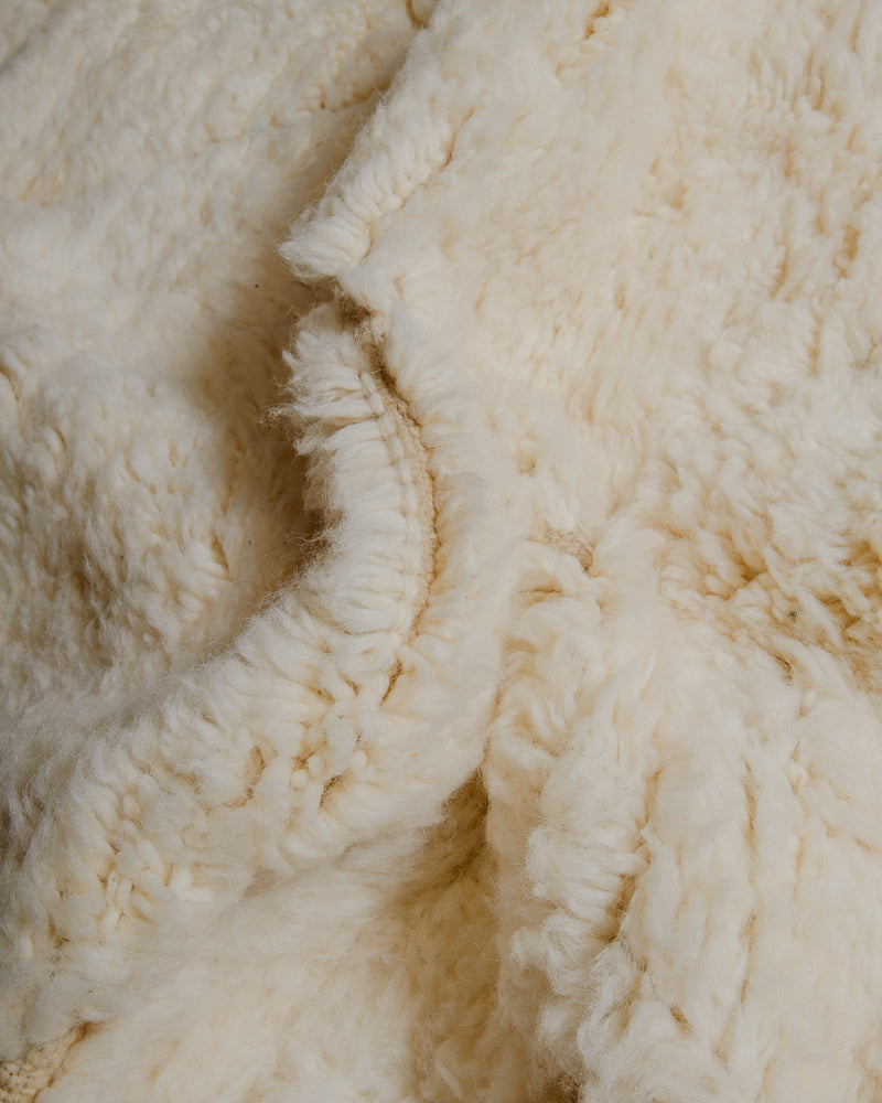 Close up of cream wool rug.
