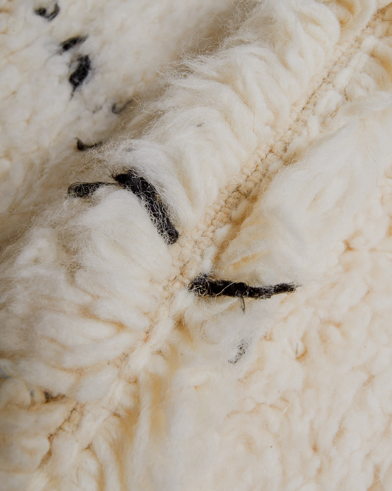 Close up of cream wool rug.