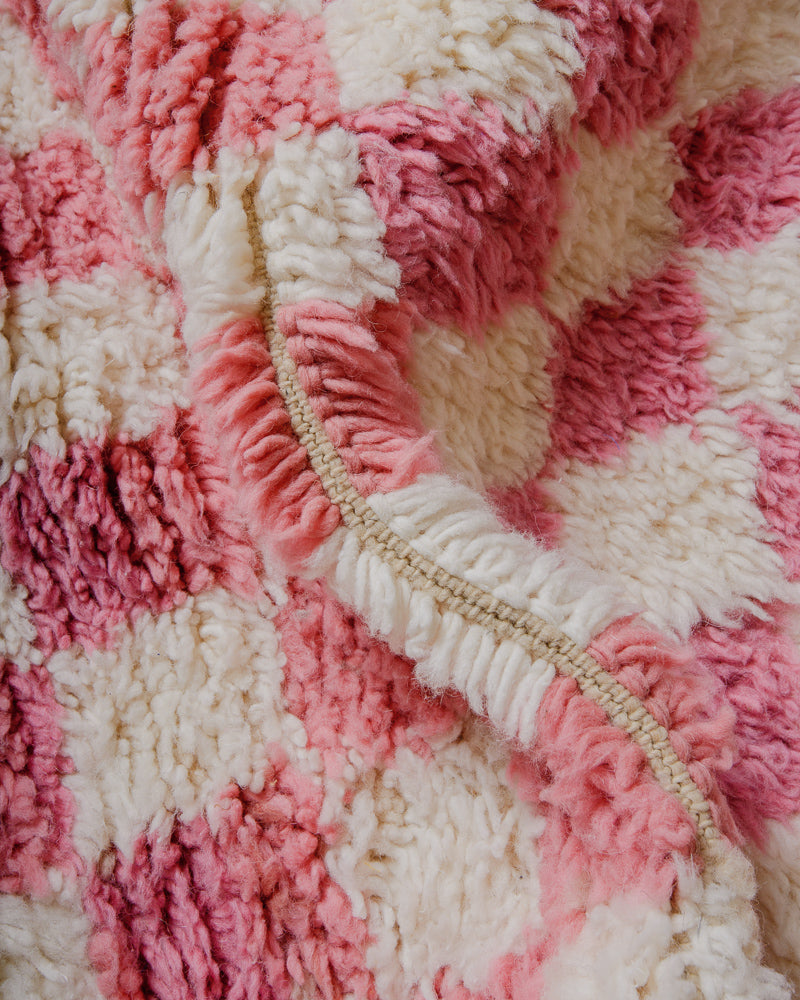 Close up of Pink checkered rug made of fluffy wool