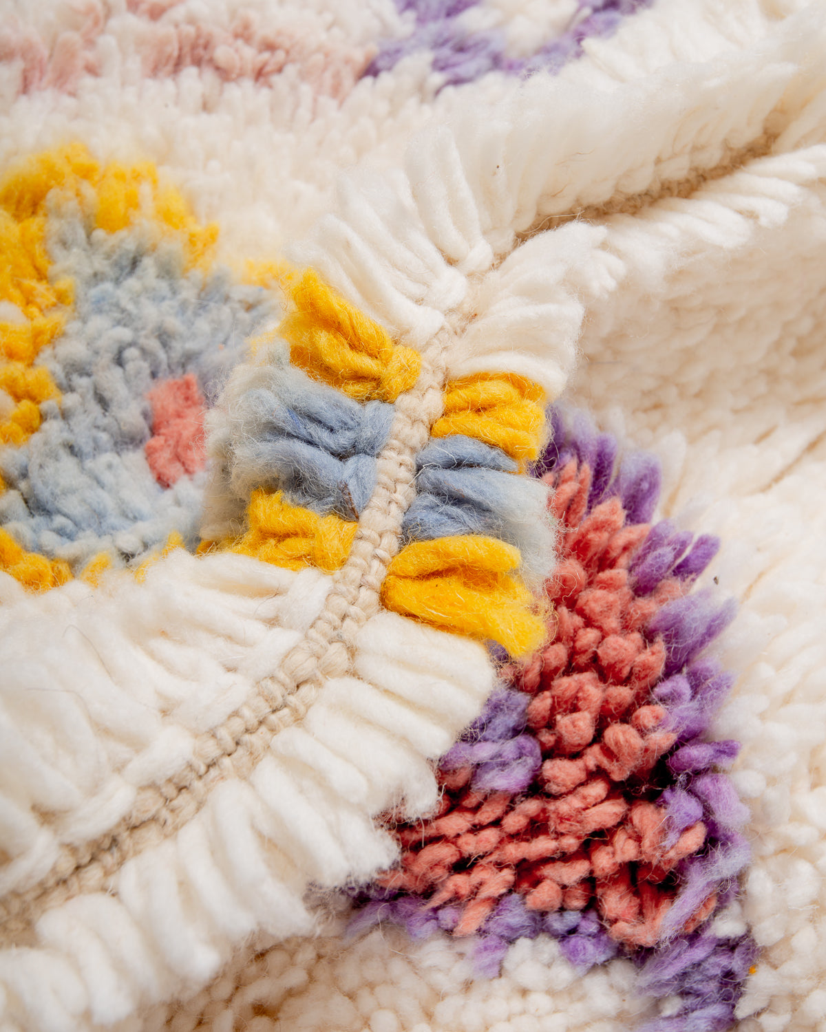 Detail of wool berber rug showing depth of pile and different coloured wool used. 