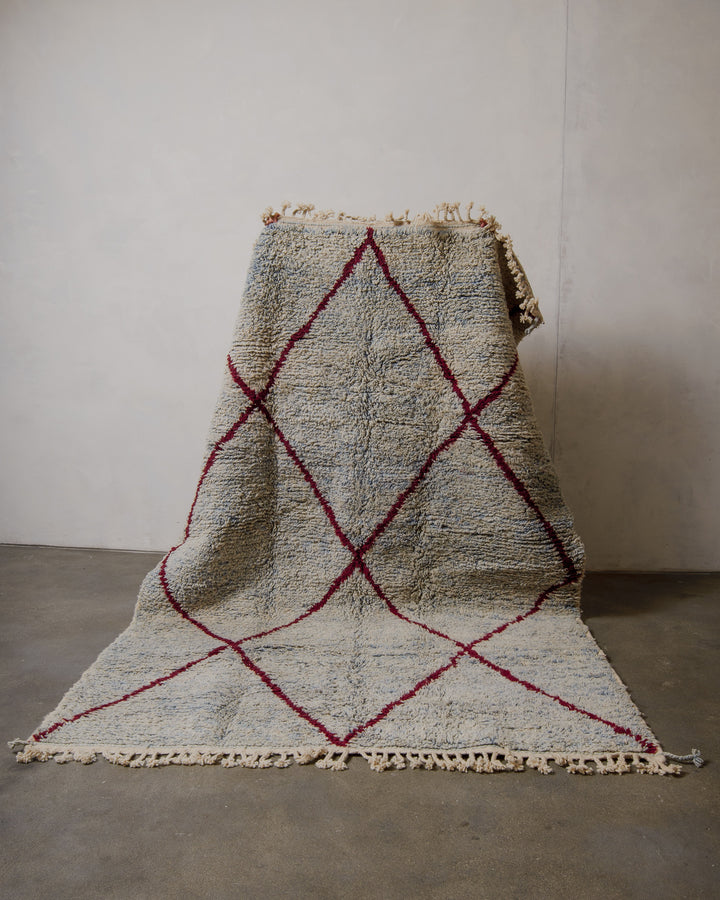 Textured rug with geometric pattern on a plain floor