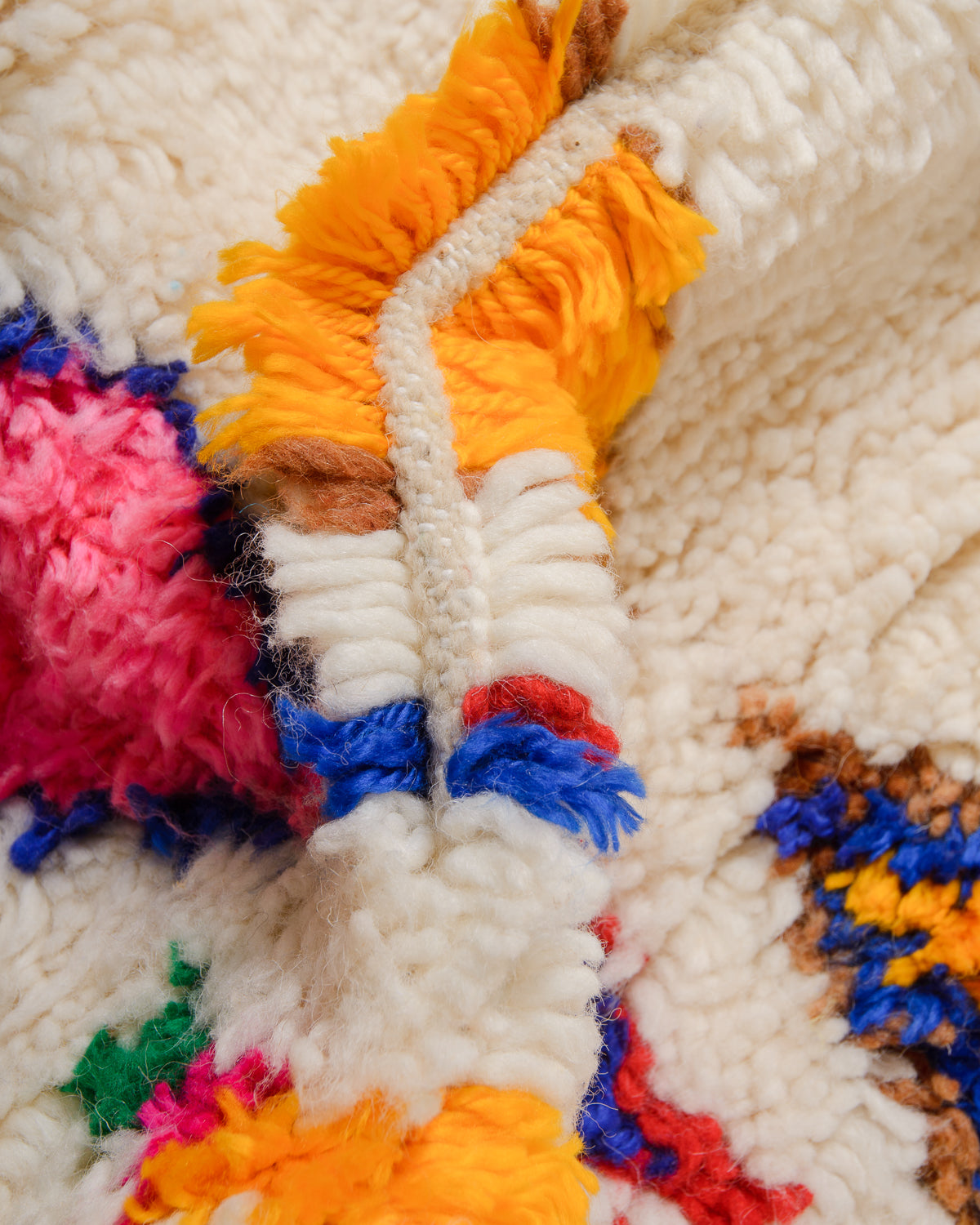 Detail of Azilal rug showing the spacing of the knotted rows and fluffy texture of the wool and soft cotton.