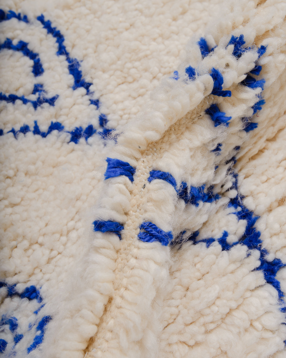 Detail of Azilal rug showing the spacing of the knotted rows and fluffy texture of the wool and soft cotton.