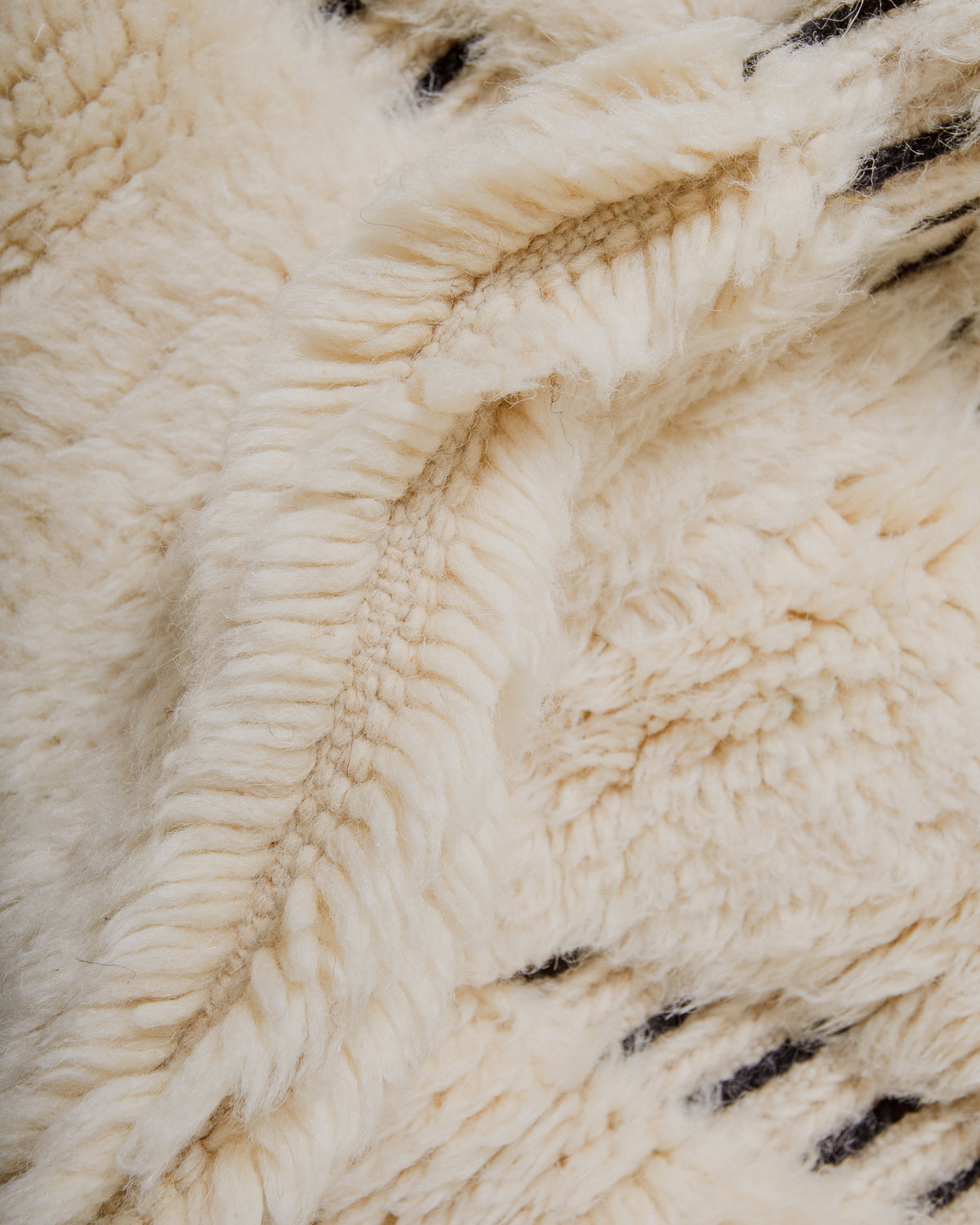 Close-up of cream wool rug.