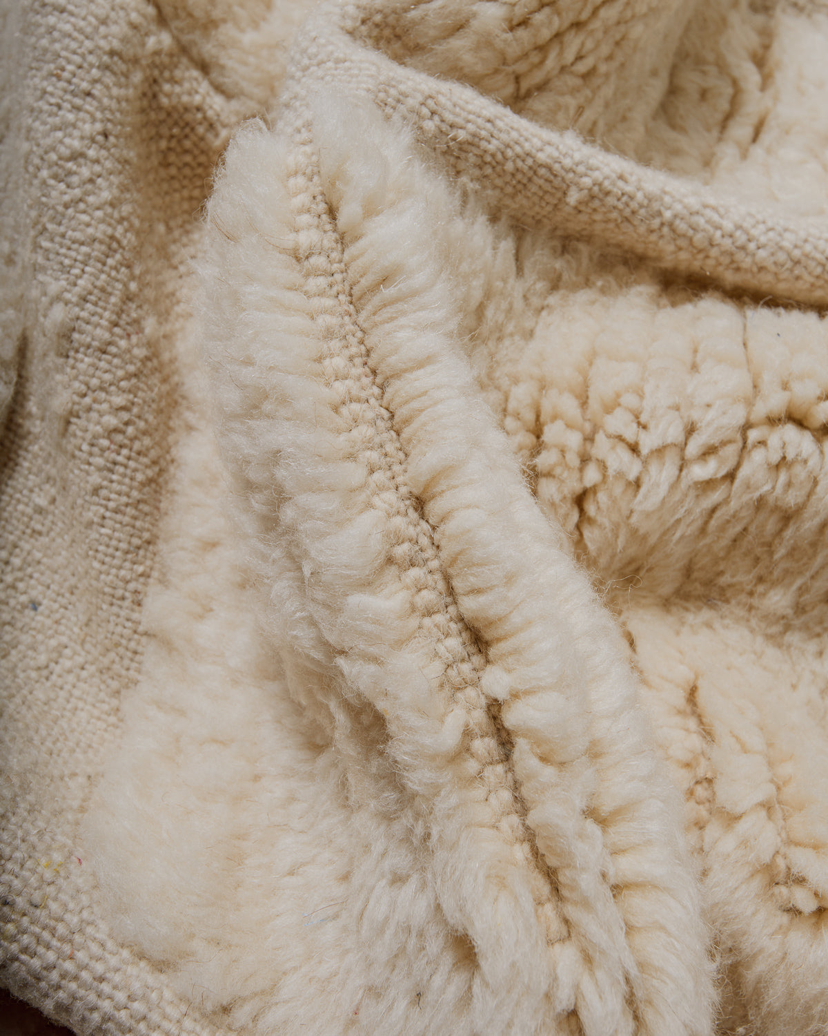 Close-up of a textured wool rug with a soft, plush surface.