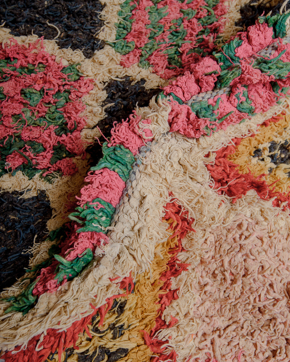 Close up of boucherouite rug with colourful cotton and fabric remnants.