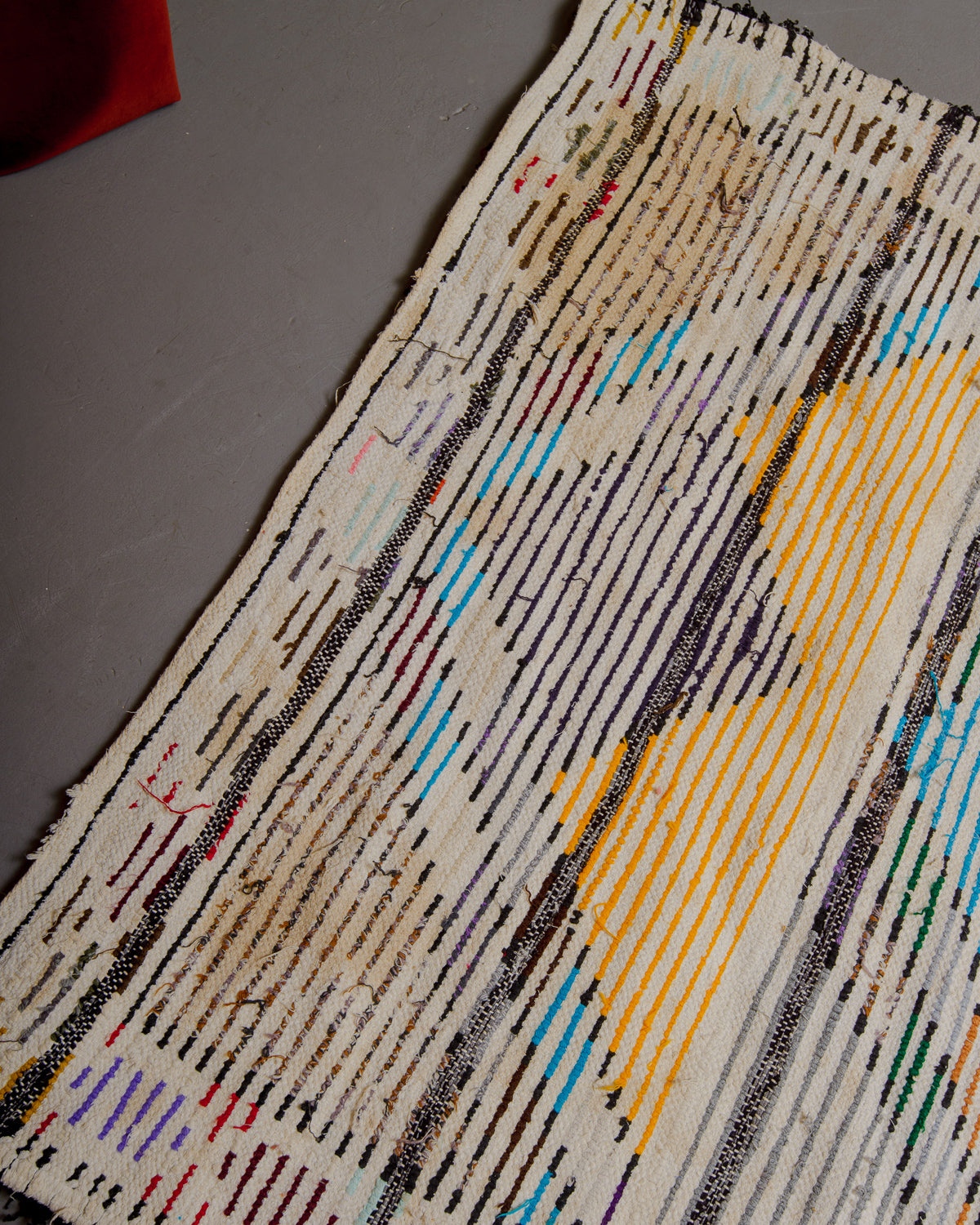 Back corner of boucherouite rug with stained area.