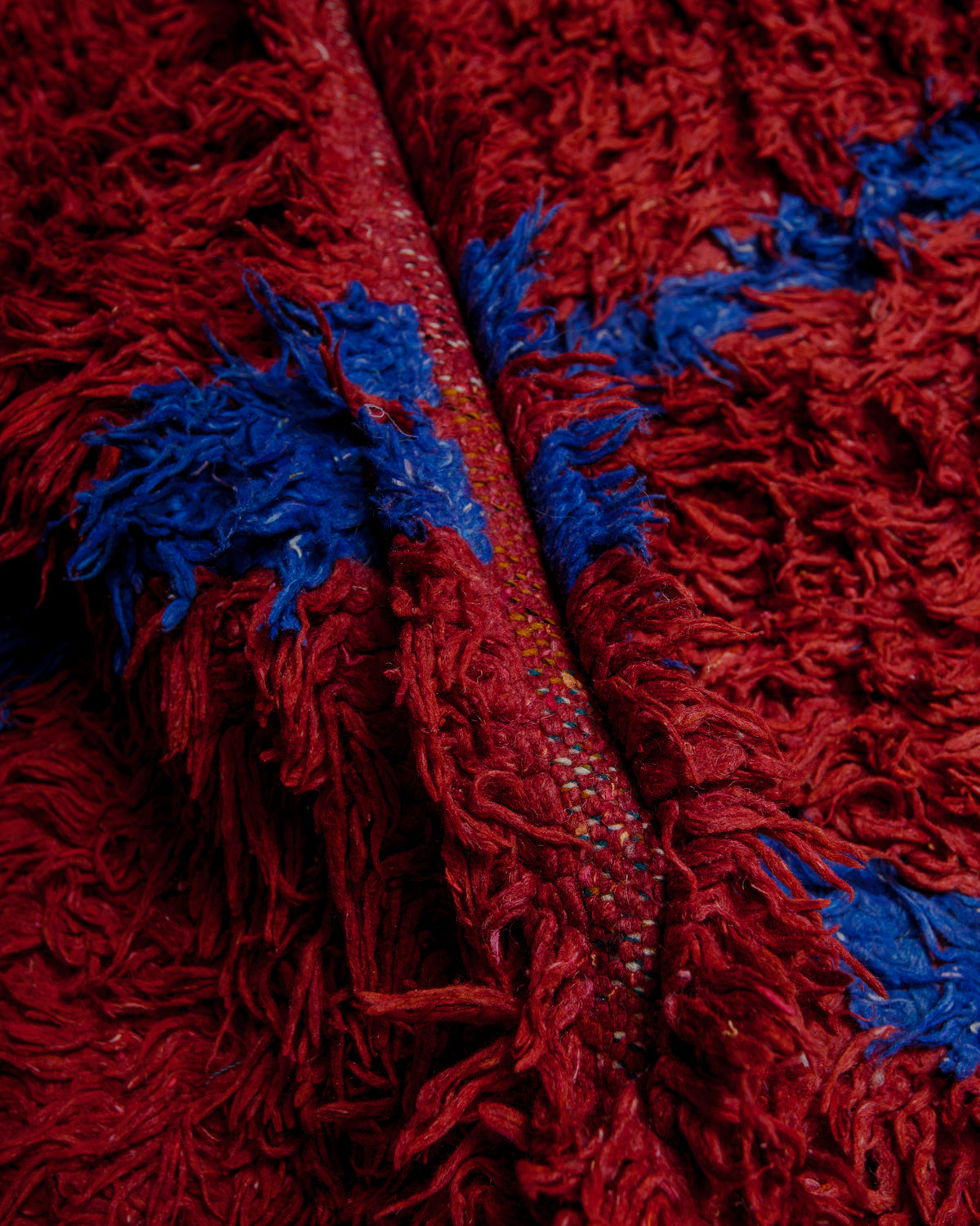 Close up of boucherouite rug with colourful cotton and fabric remnants.