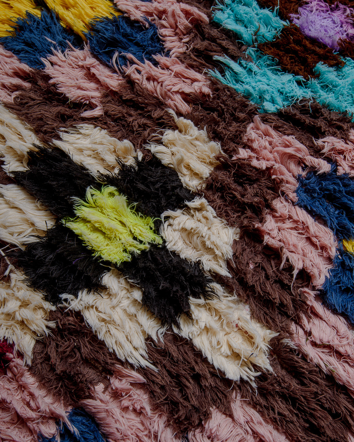 Close up of boucherouite rug with colourful cotton and fabric remnants.