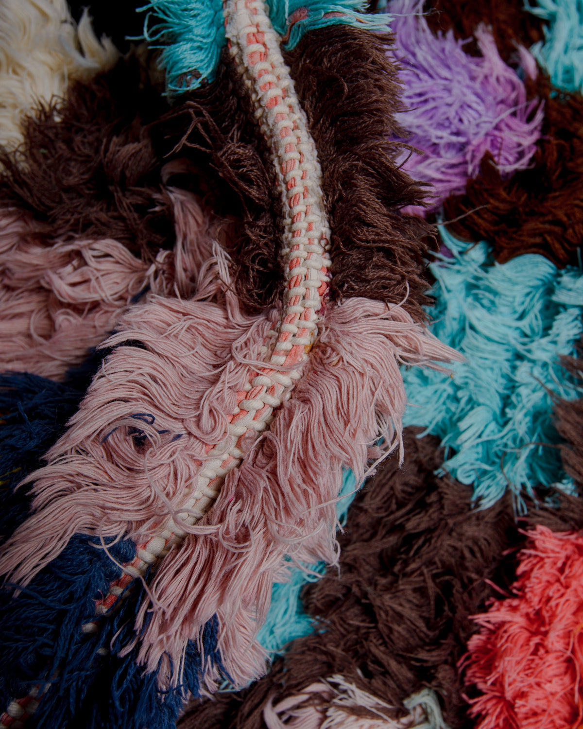 Close up of boucherouite rug with colourful cotton and fabric remnants.