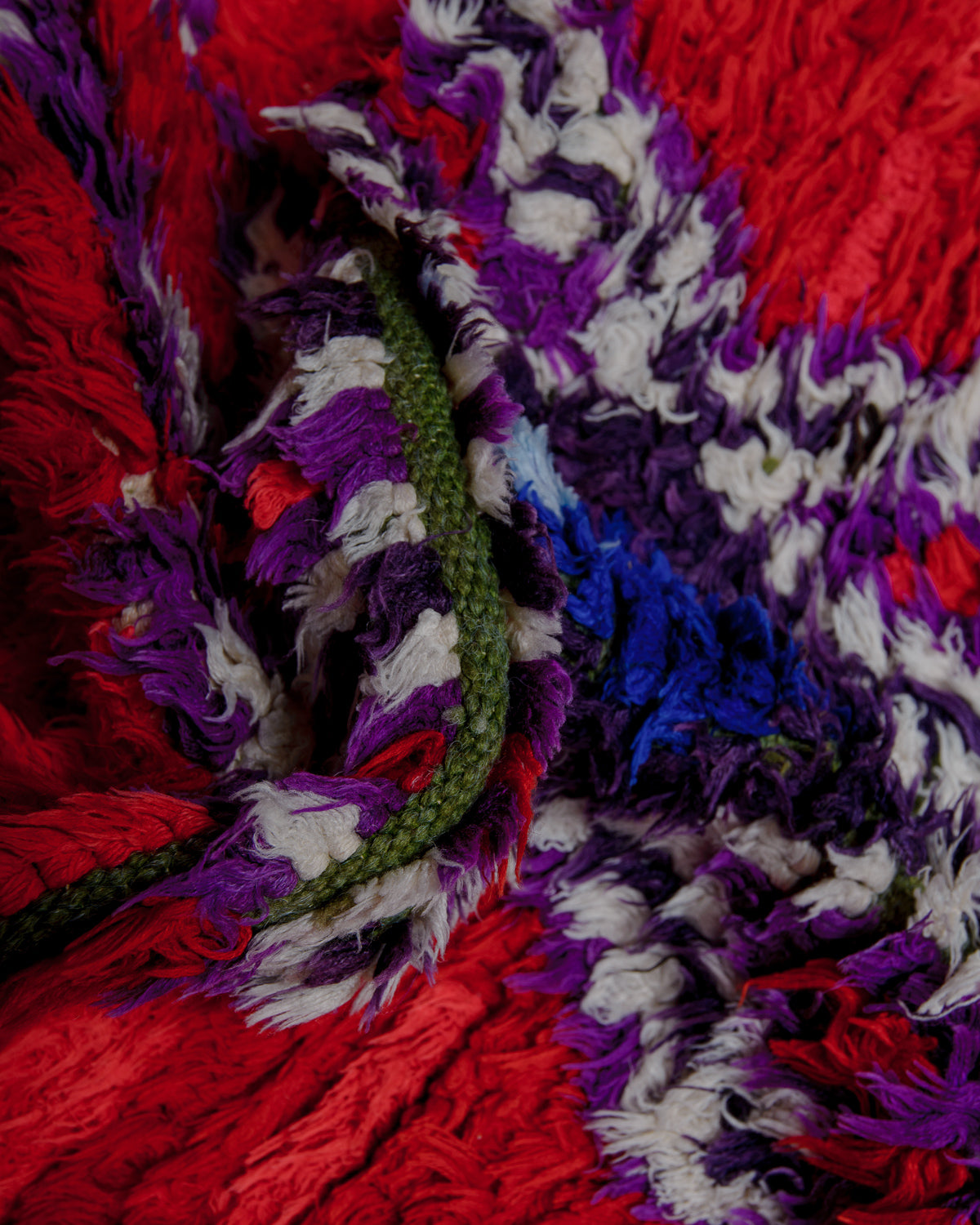 Close up of boucherouite rug with colourful cotton and fabric remnants.